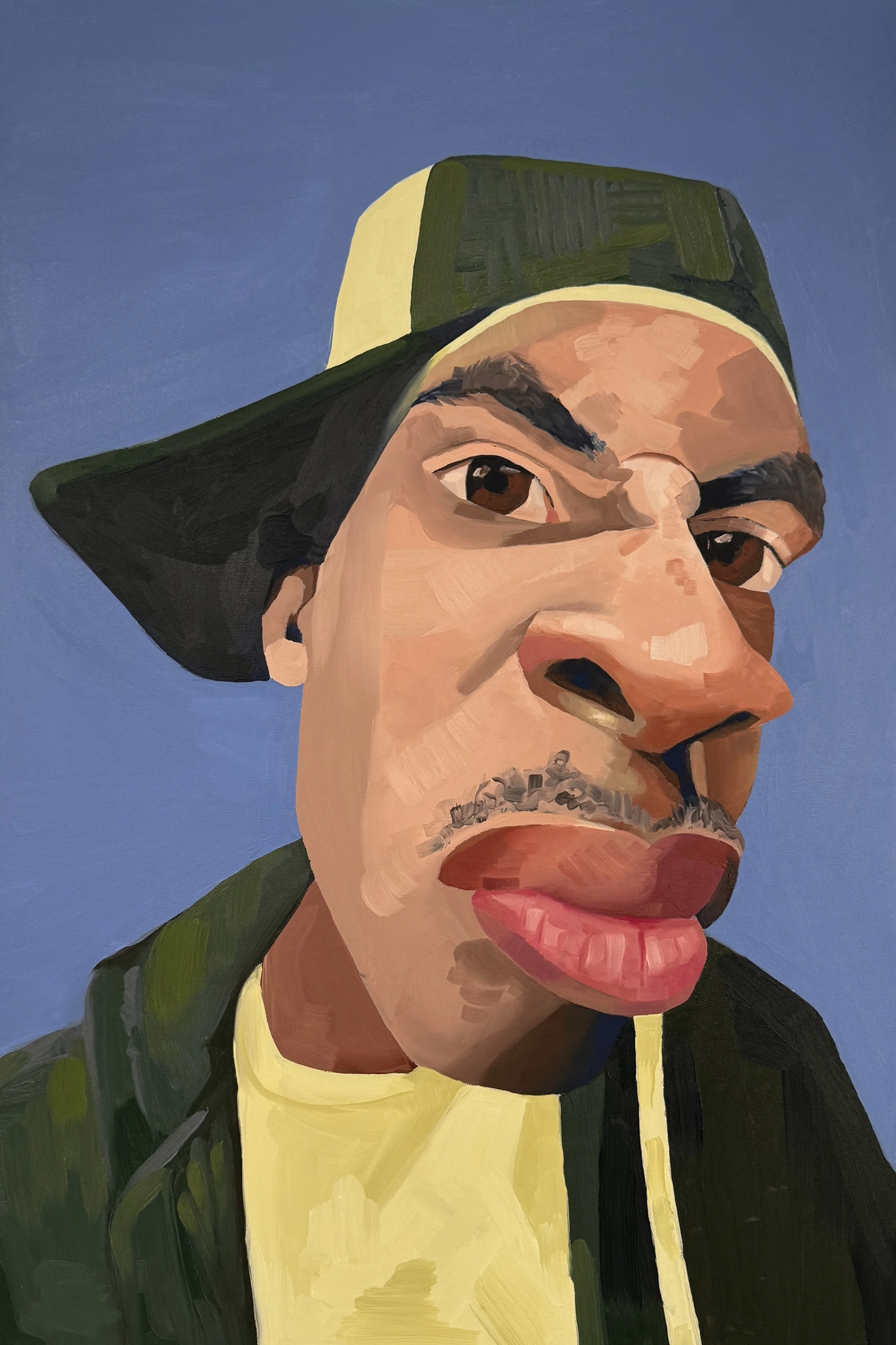 A colorful portrait of a person wearing a green and yellow cap, with facial features including brown eyes, a mustache, and a pink lip, against a blue background.