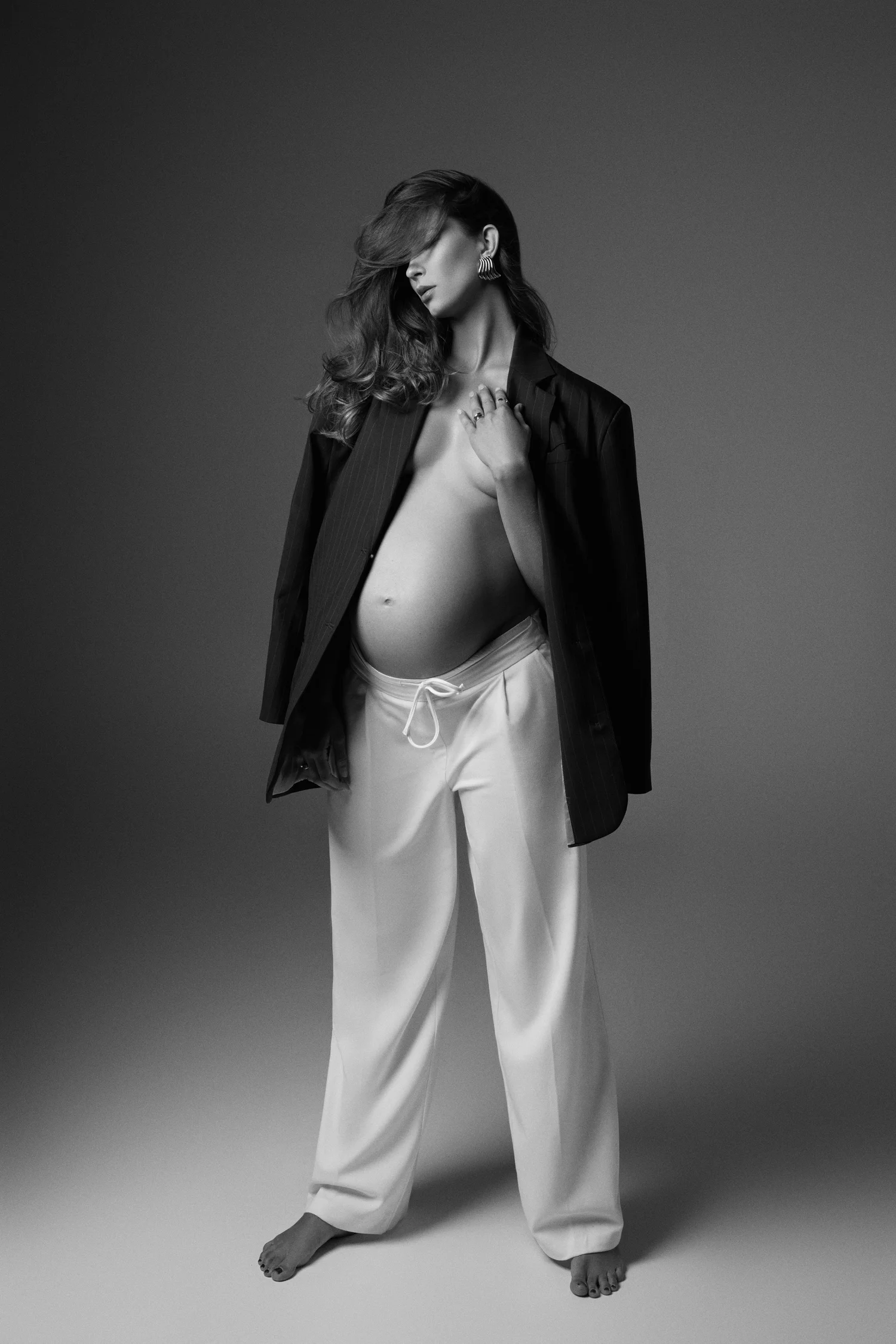 Standing studio maternity portrait, a classic posing example