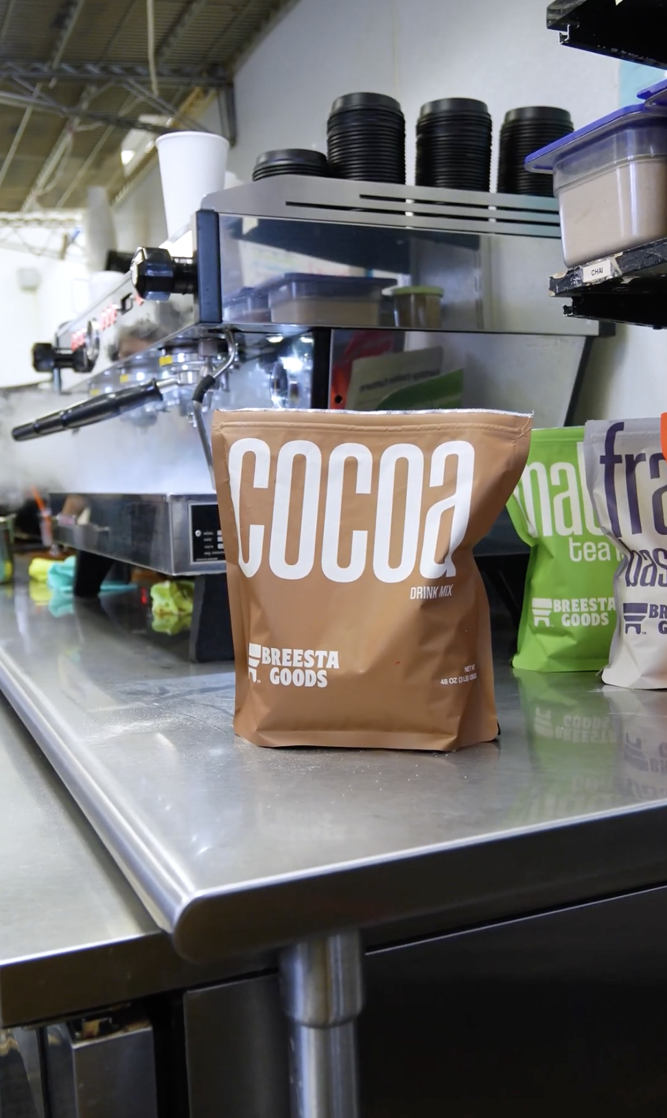 bag of cocoa sitting on counter at coffee shop