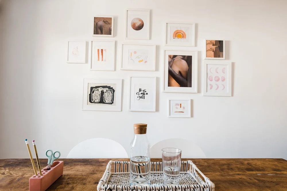 Office gallery wall featuring logo and local artwork
