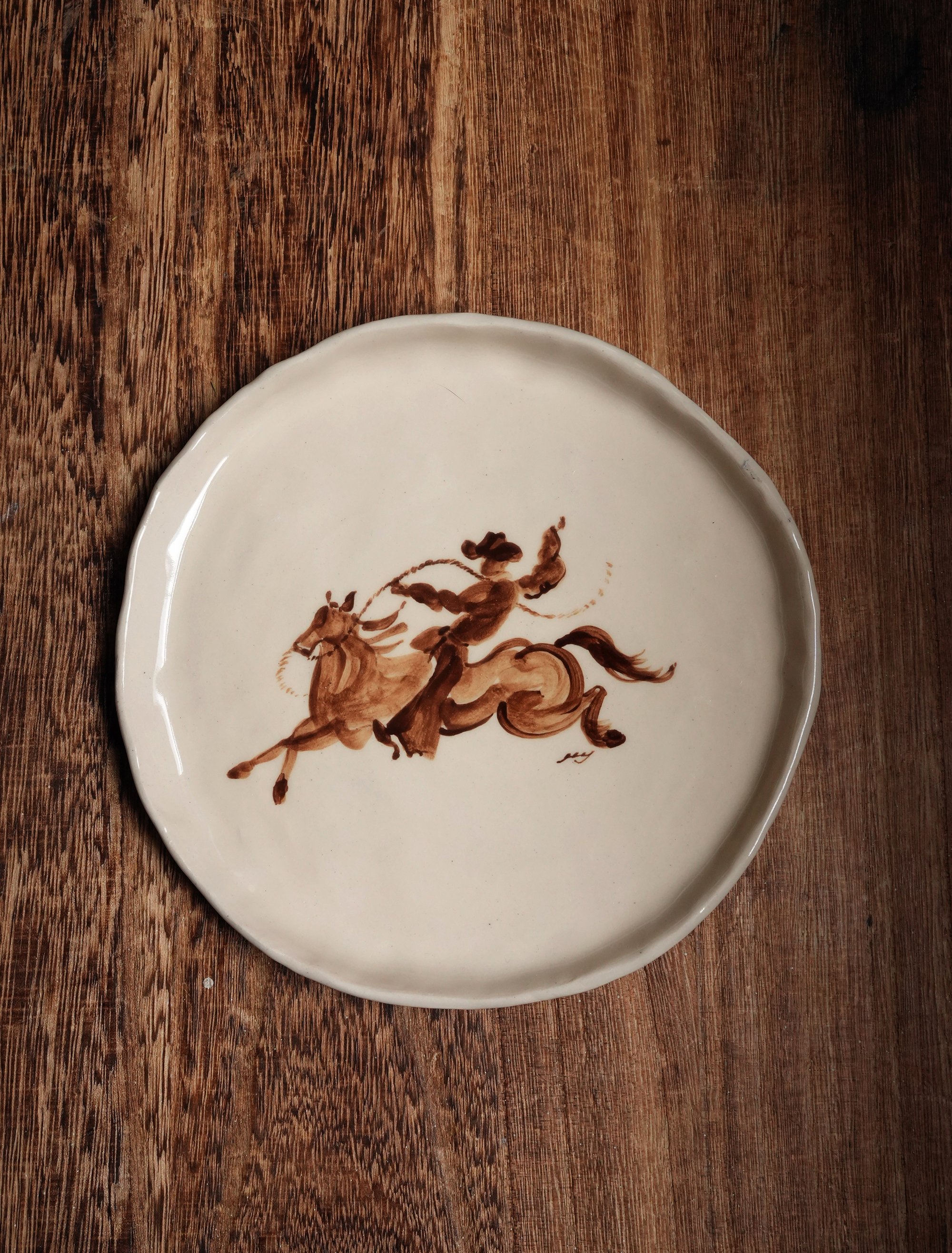 rodeo cowboy standing on horse ceramic plate handpainted handmade ceramics plates tableware dinnerware curiouscommon