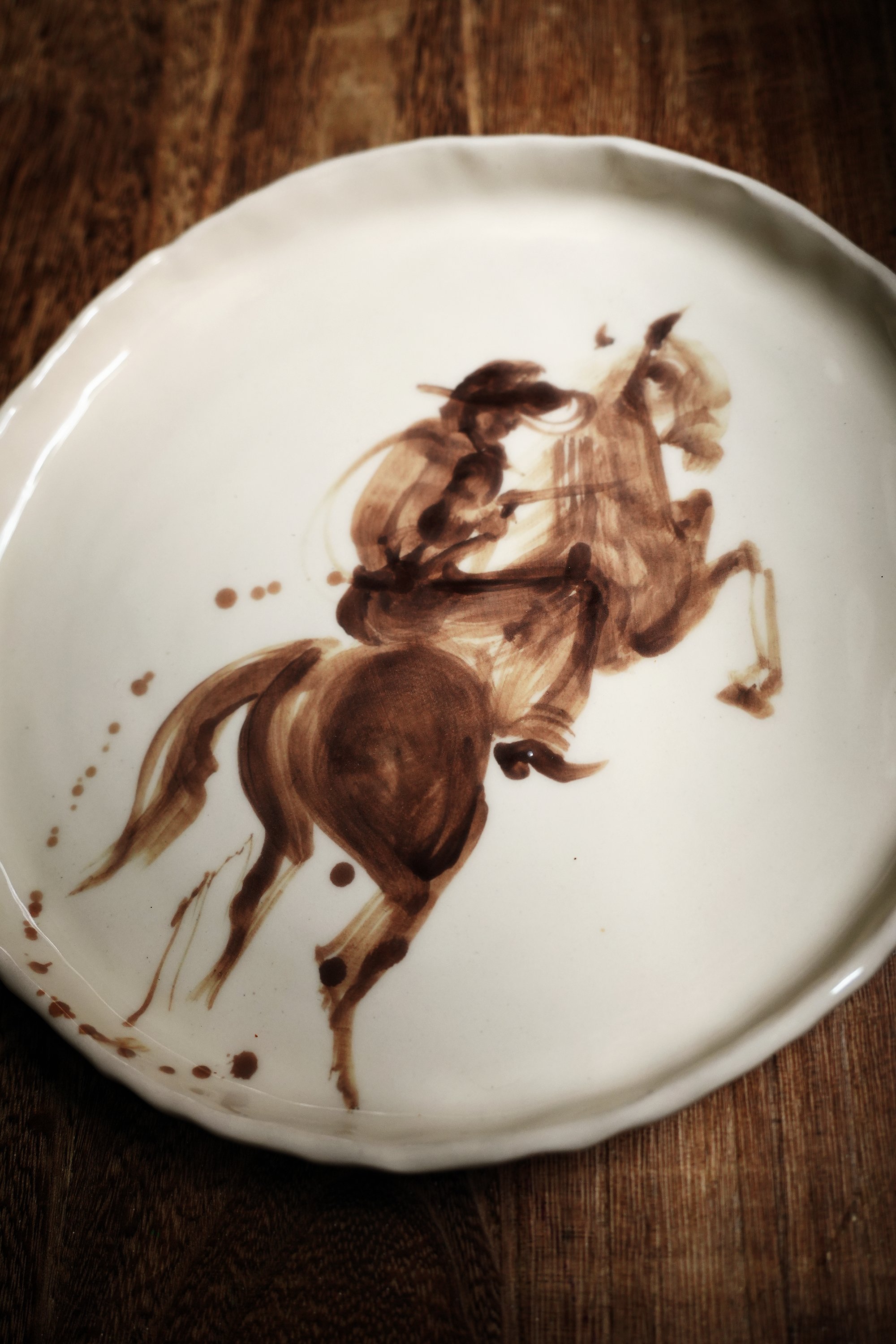Cowboy on Buckin Horse Plate by Robyn Yeang Western tableware & handmade ceramic dinnerware, hand-painted with cowboy on a bucking bronco horse rodeo art