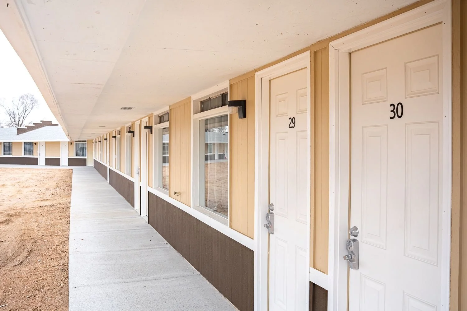 Apartment doors numbered 29 and 30 along a walkway outside a building.