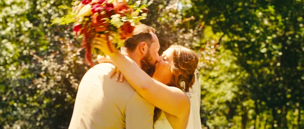 A couple kissing during their backyard wedding ceremony in Lincoln.