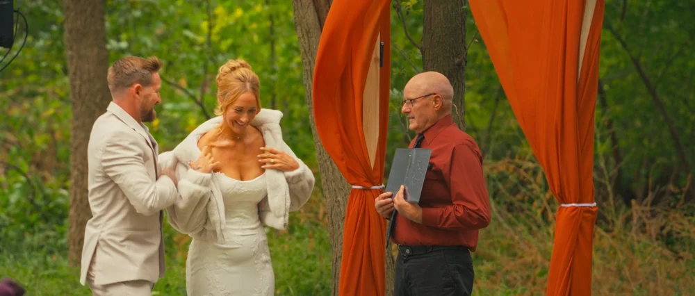 Abby and Daniel sharing a light moment with their officiant.