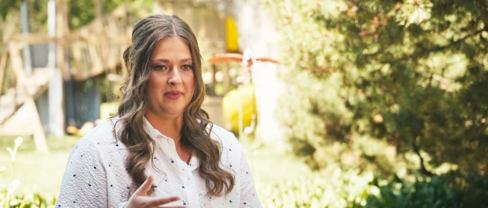 Bre speaking in an outdoor wedding-day interview.