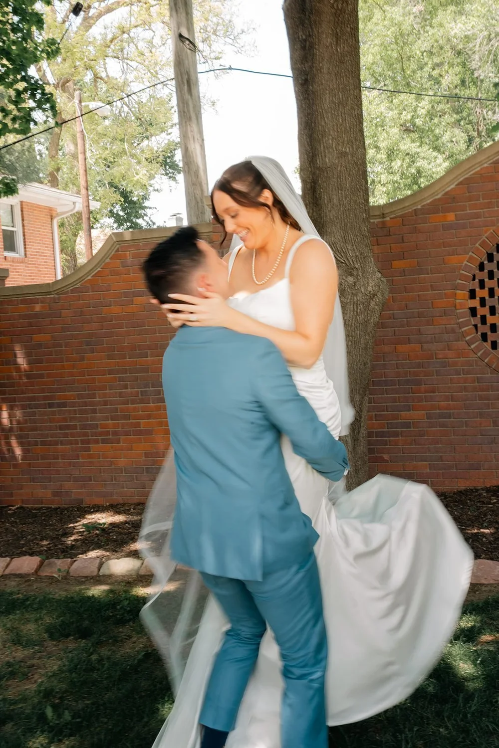 Grace and Alex laugh together during playful wedding portraits at the Ford Birthsite