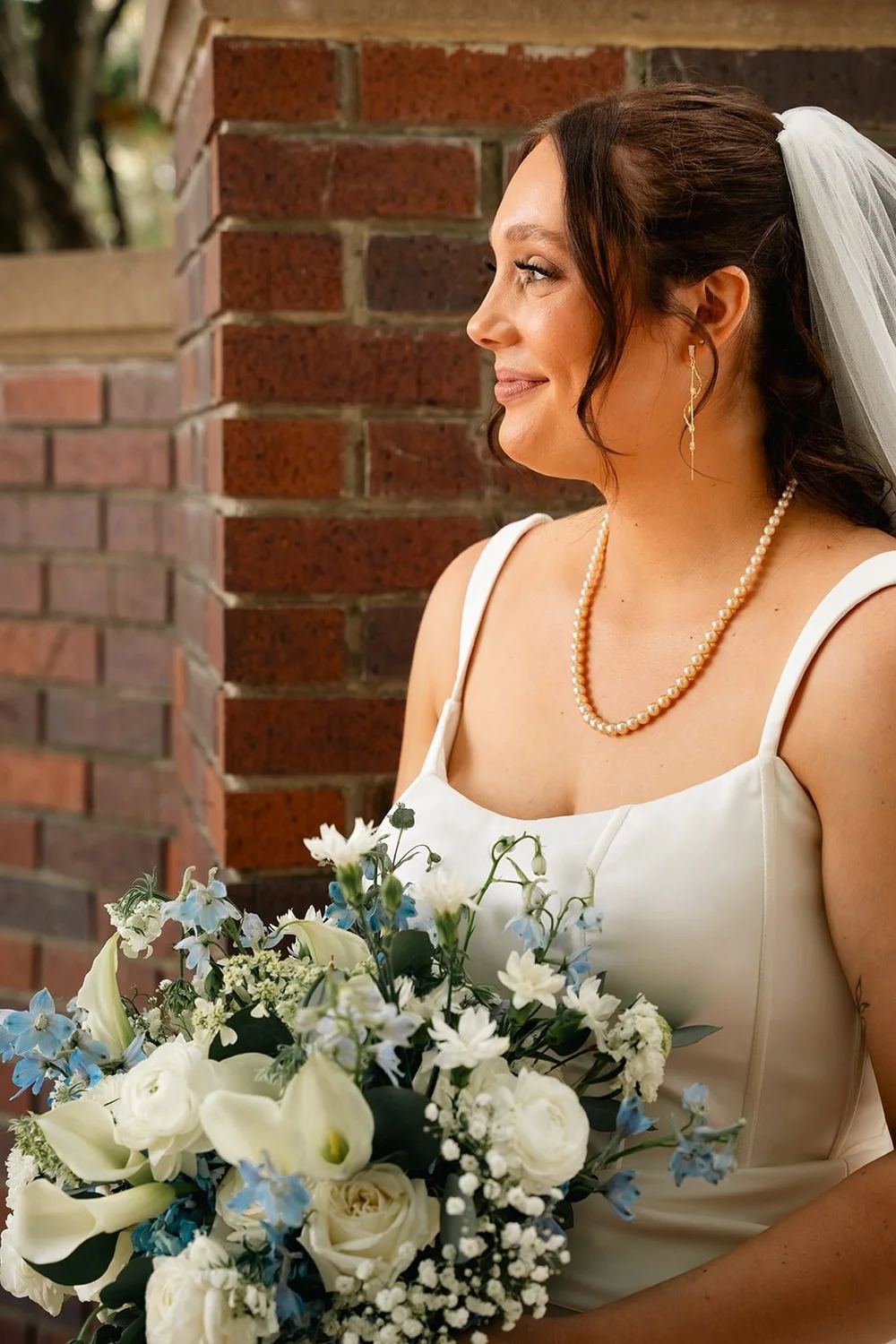 Grace holds her bouquet for a bridal portrait in the Ford Birthsite gardens