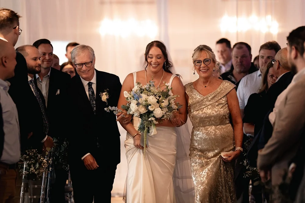 Grace enters The Diamond Room with her family for her Omaha wedding ceremony