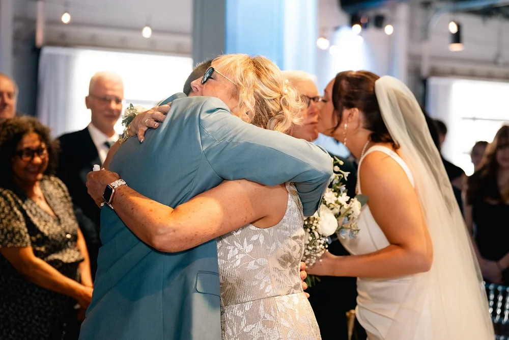 Grace shares an emotional family hug during her Diamond Room wedding ceremony