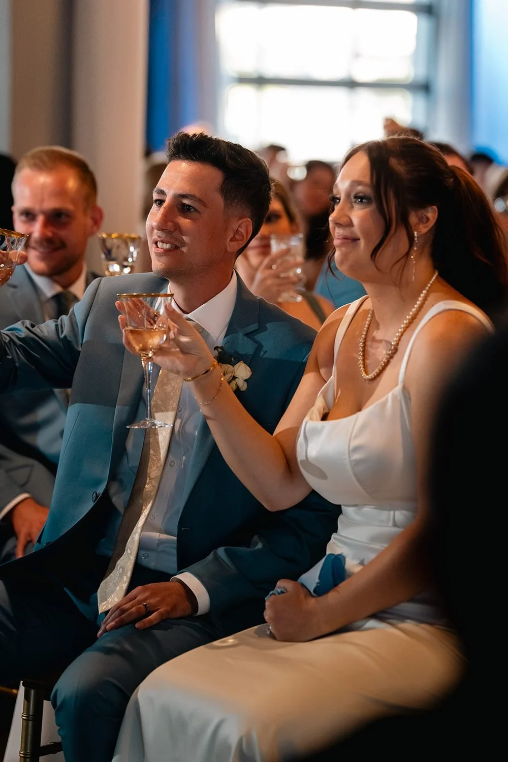 Grace and Alex raise a glass together at their Diamond Room wedding reception
