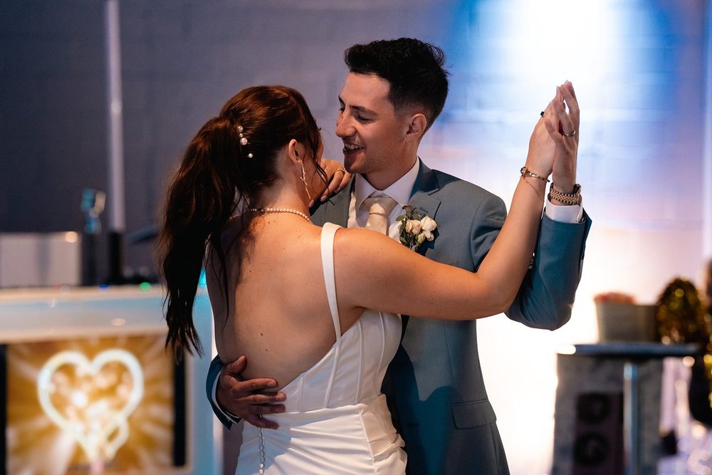 Grace and Alex share their first dance beneath the lights at The Diamond Room