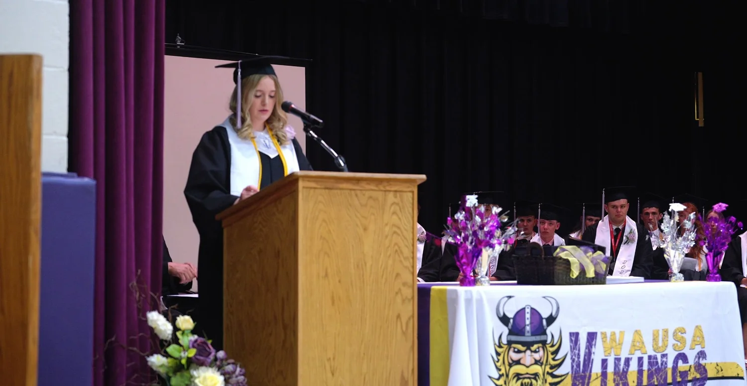 A graduate speaks at the podium during the Wausa Public Schools 2024 graduation ceremony