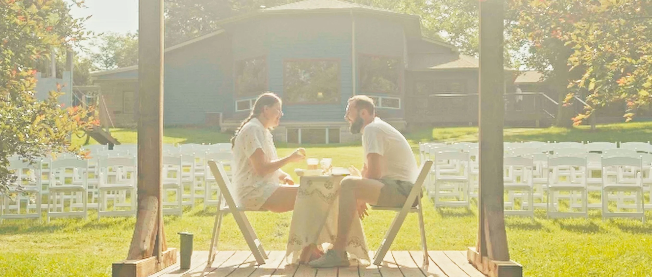 Bride and groom at altar during outdoor wedding ceremony at family home in Lincoln Nebraska