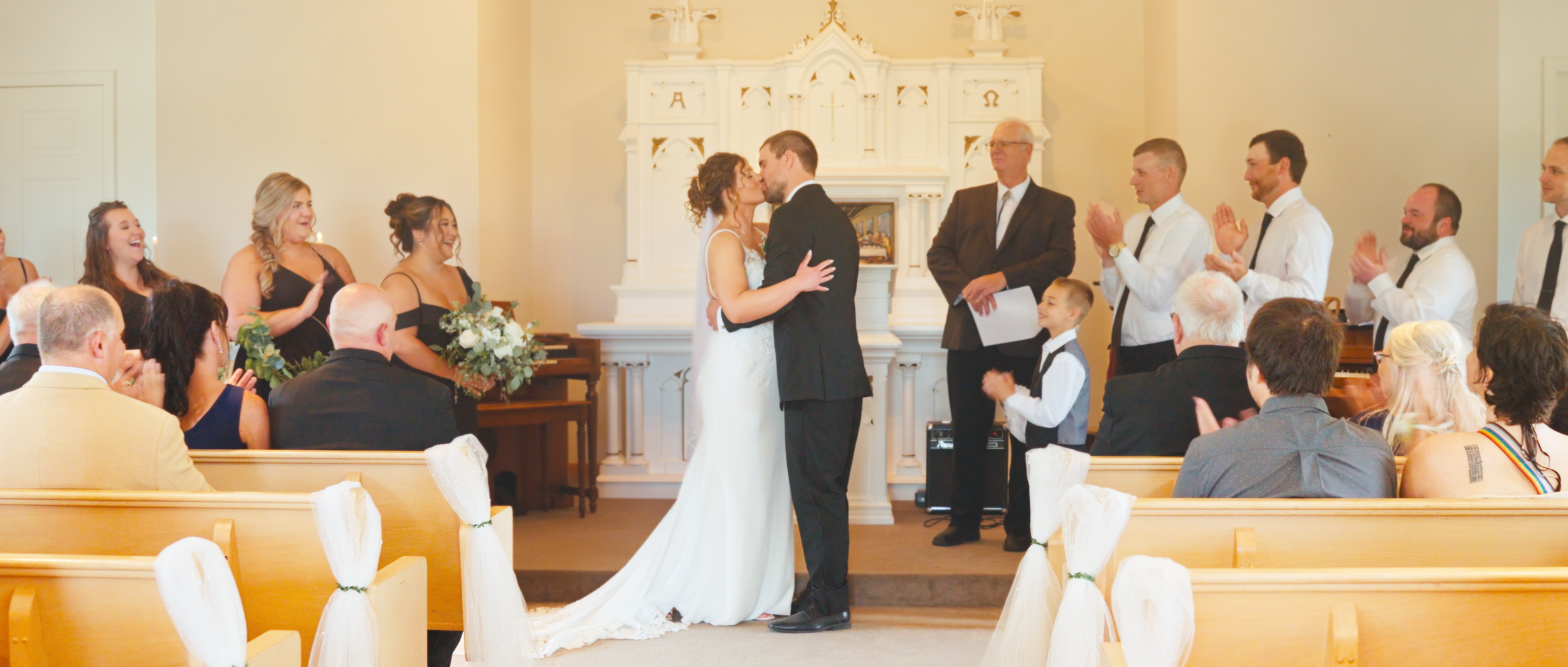 bride-and-groom-kissing-ceremony-prairie-hope-chapel.png