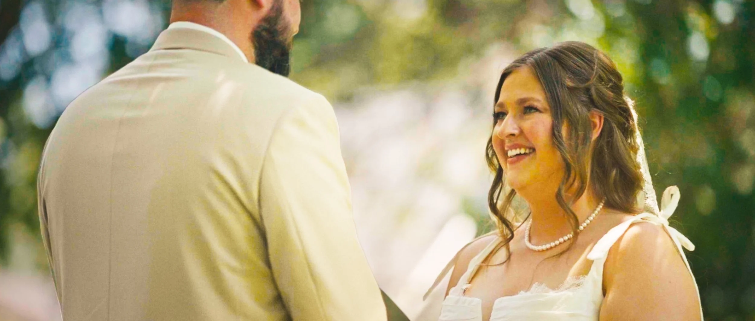  Backyard wedding ceremony setup at family home in Lincoln Nebraska with trees surrounding the property 