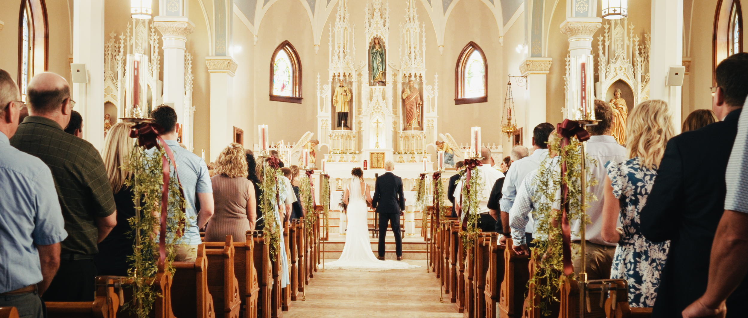 Bride and Groom standing in the center of the aisle of ceremony
