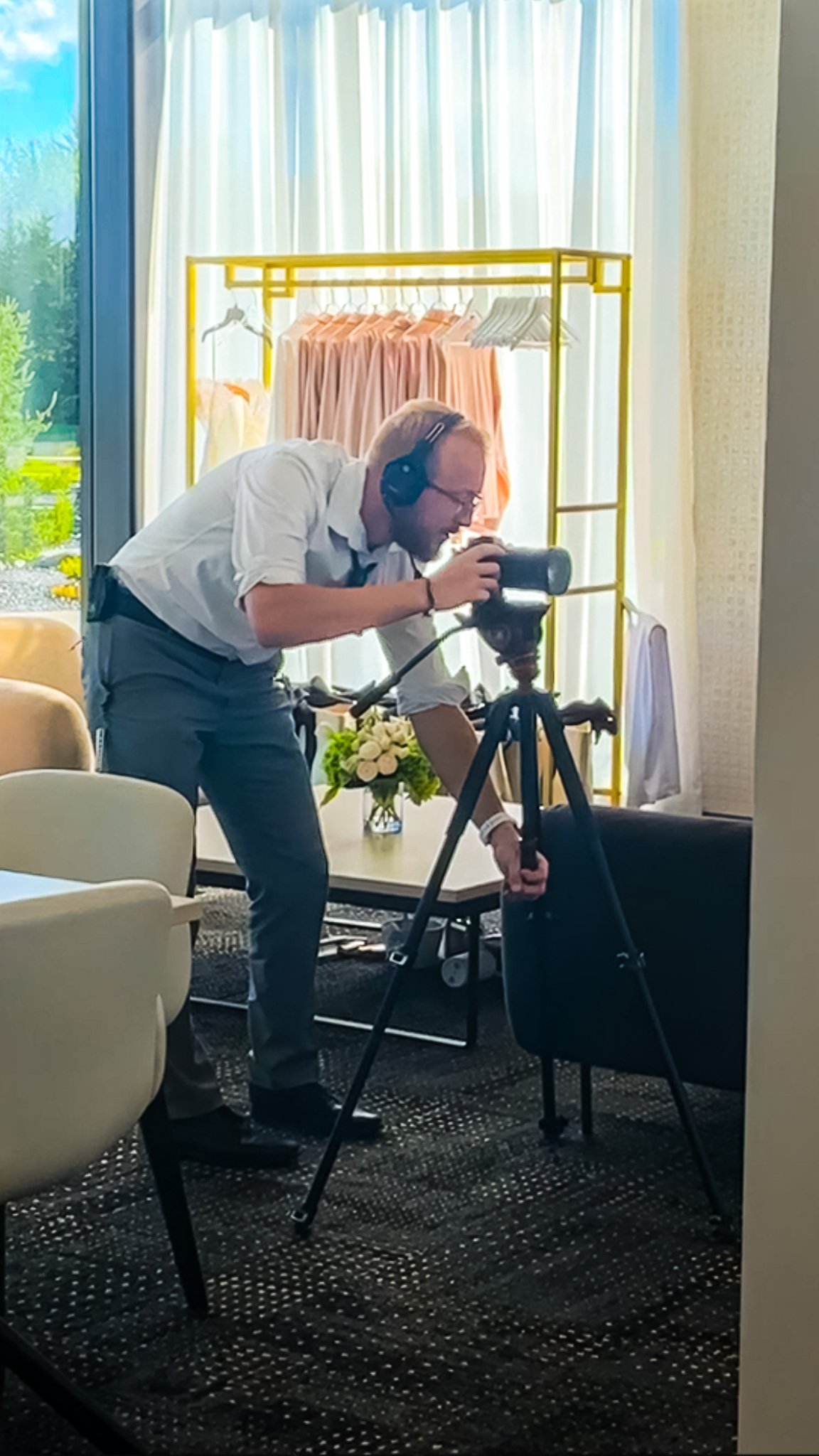 Behind-the-scenes wedding videographer capturing footage at Venue 5 Twenty-Two in Lincoln, Nebraska with professional camera setup and natural light