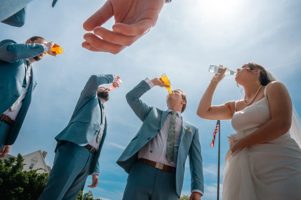 Grace and Alex celebrating with their wedding party in Omaha.