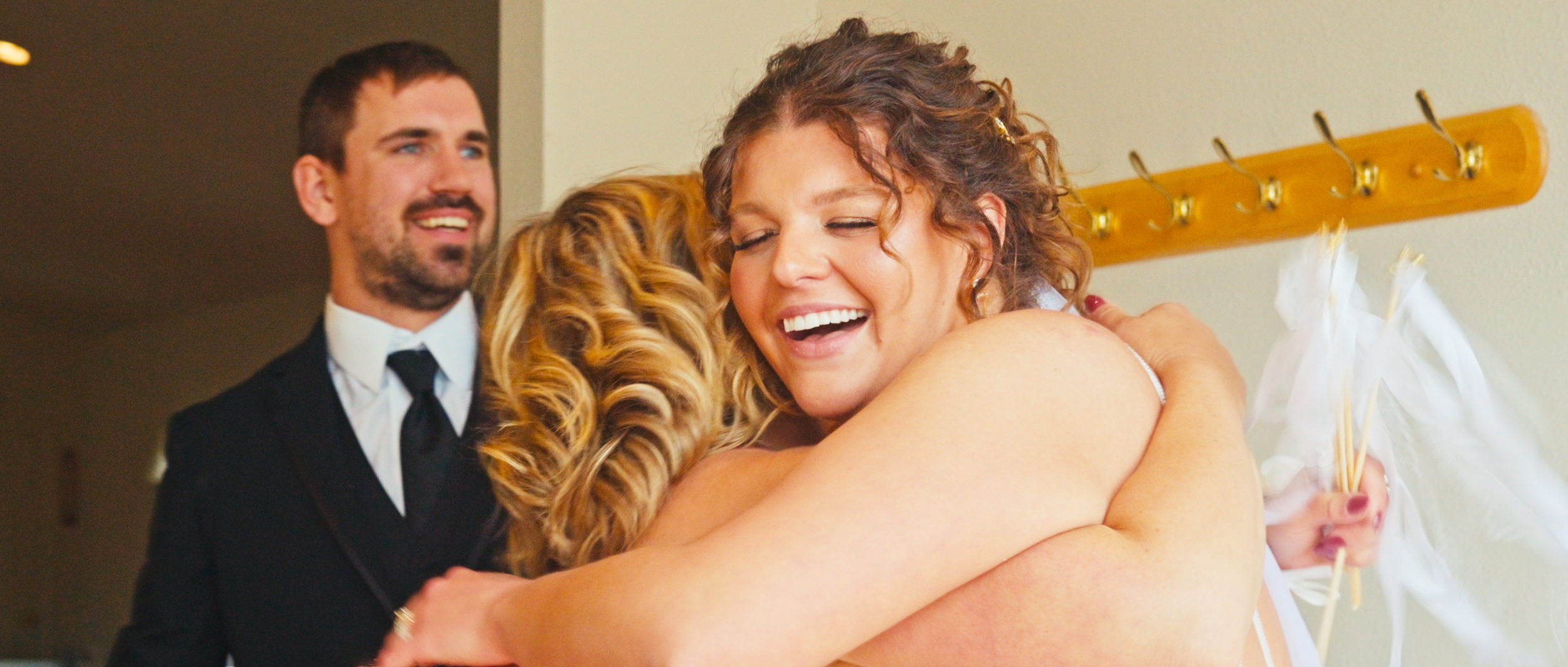bride-hugging-guest-after-ceremony-prairie-hope-chapel.png