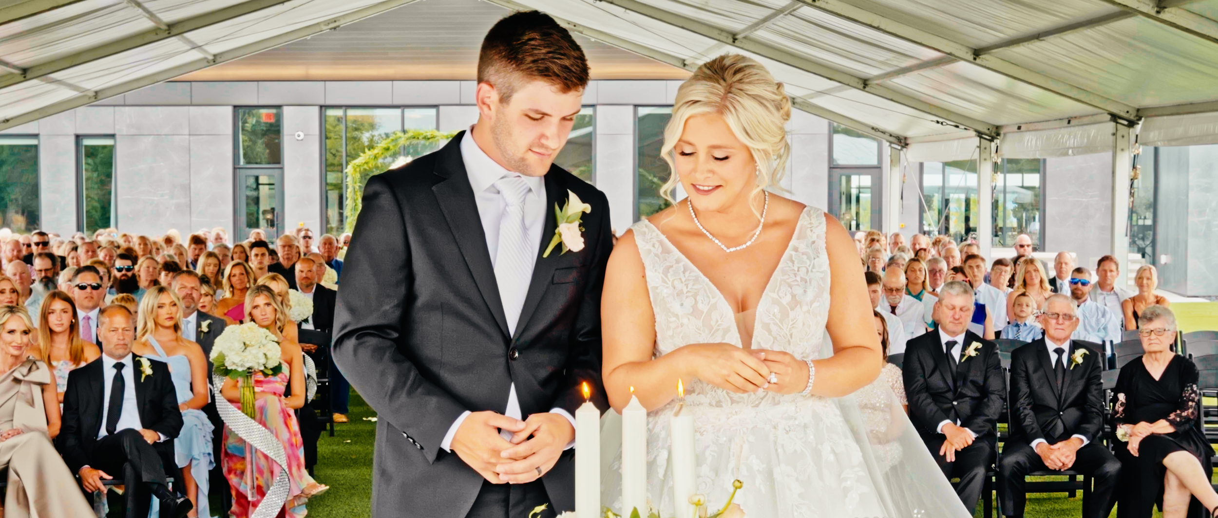 Kylie and Chase lighting a unity candle during their wedding ceremony at Venue 5 Twenty-Two in Lincoln