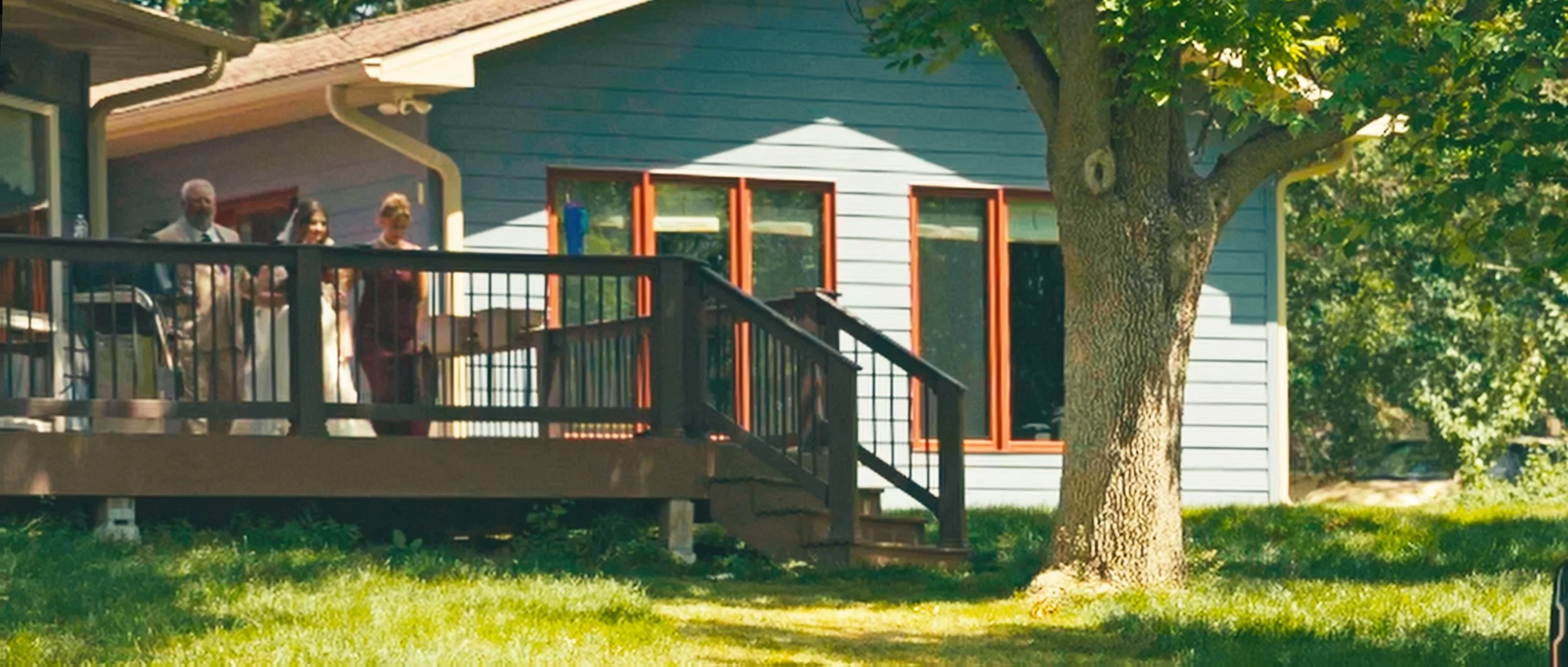 Family home exterior with deck during backyard wedding day in Lincoln Nebraska