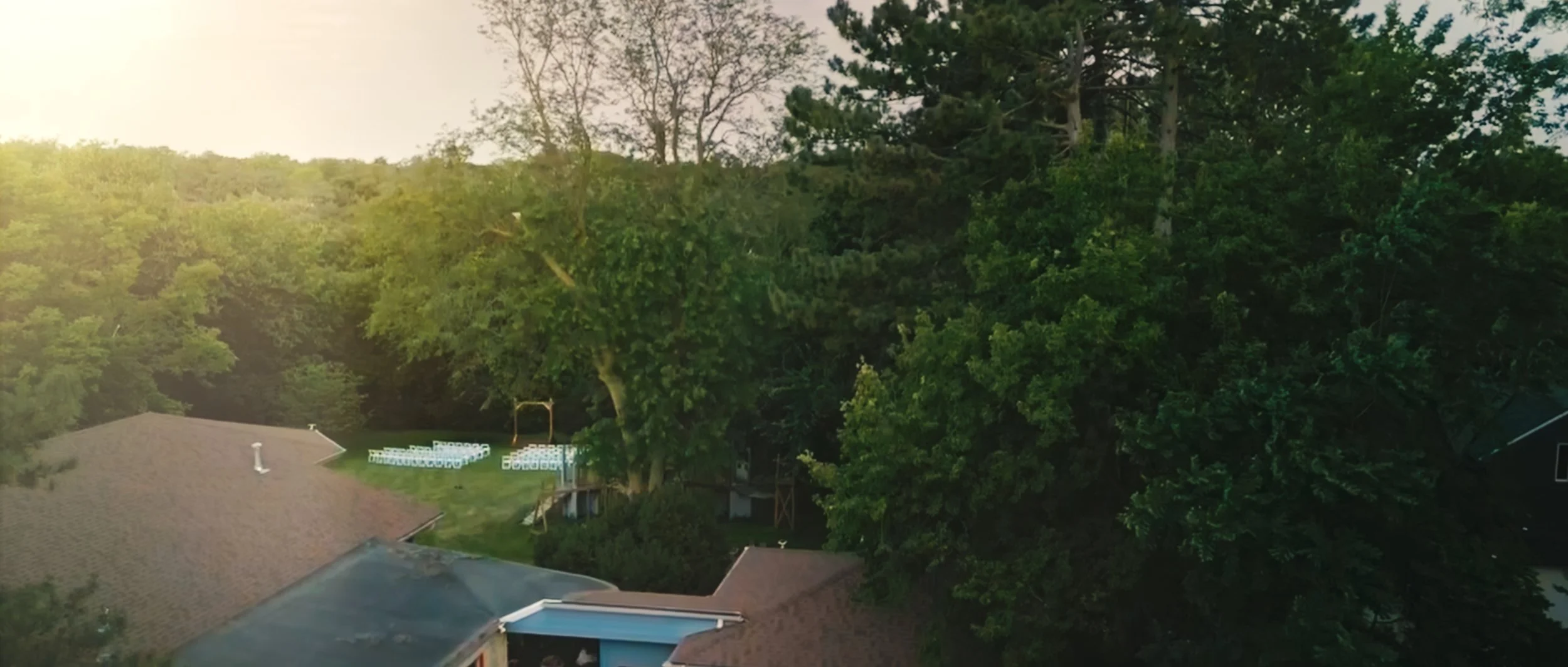 Aerial view of backyard wedding location at family home in Lincoln Nebraska surrounded by trees