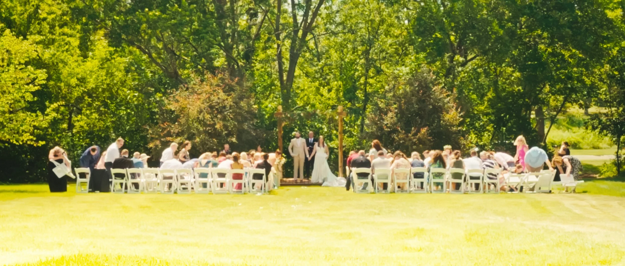 Backyard wedding ceremony with guests seated outdoors in Lincoln Nebraska summer