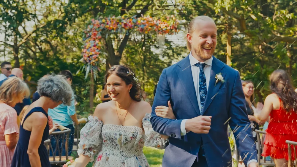 Bride and groom smiling and laughing while walking down the aisle during a wedding ceremony in Pierce, Nebraska