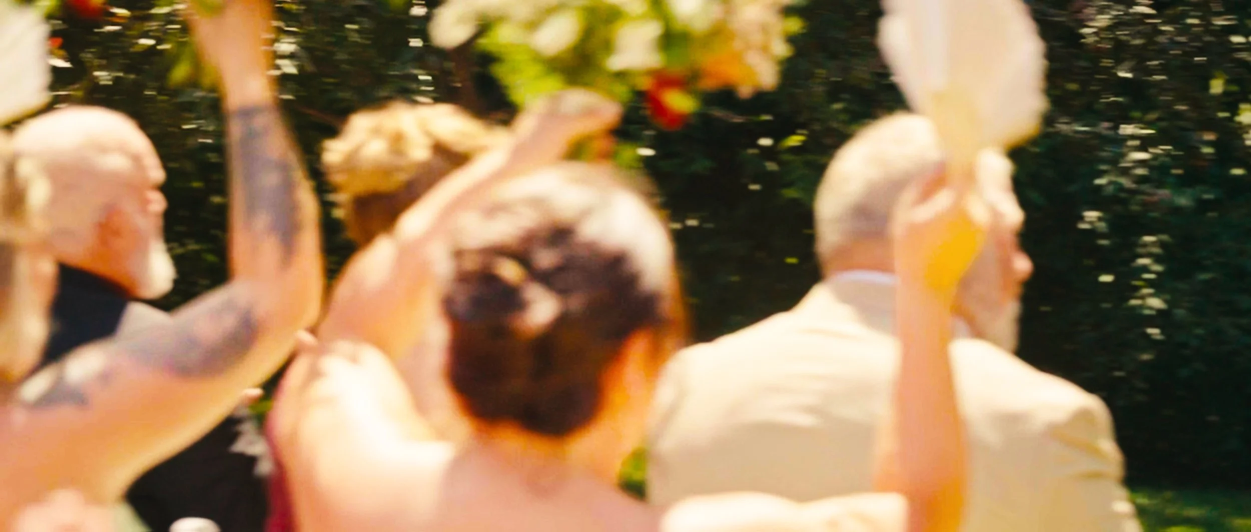 Wedding guests walking across lawn after backyard ceremony in Lincoln Nebraska