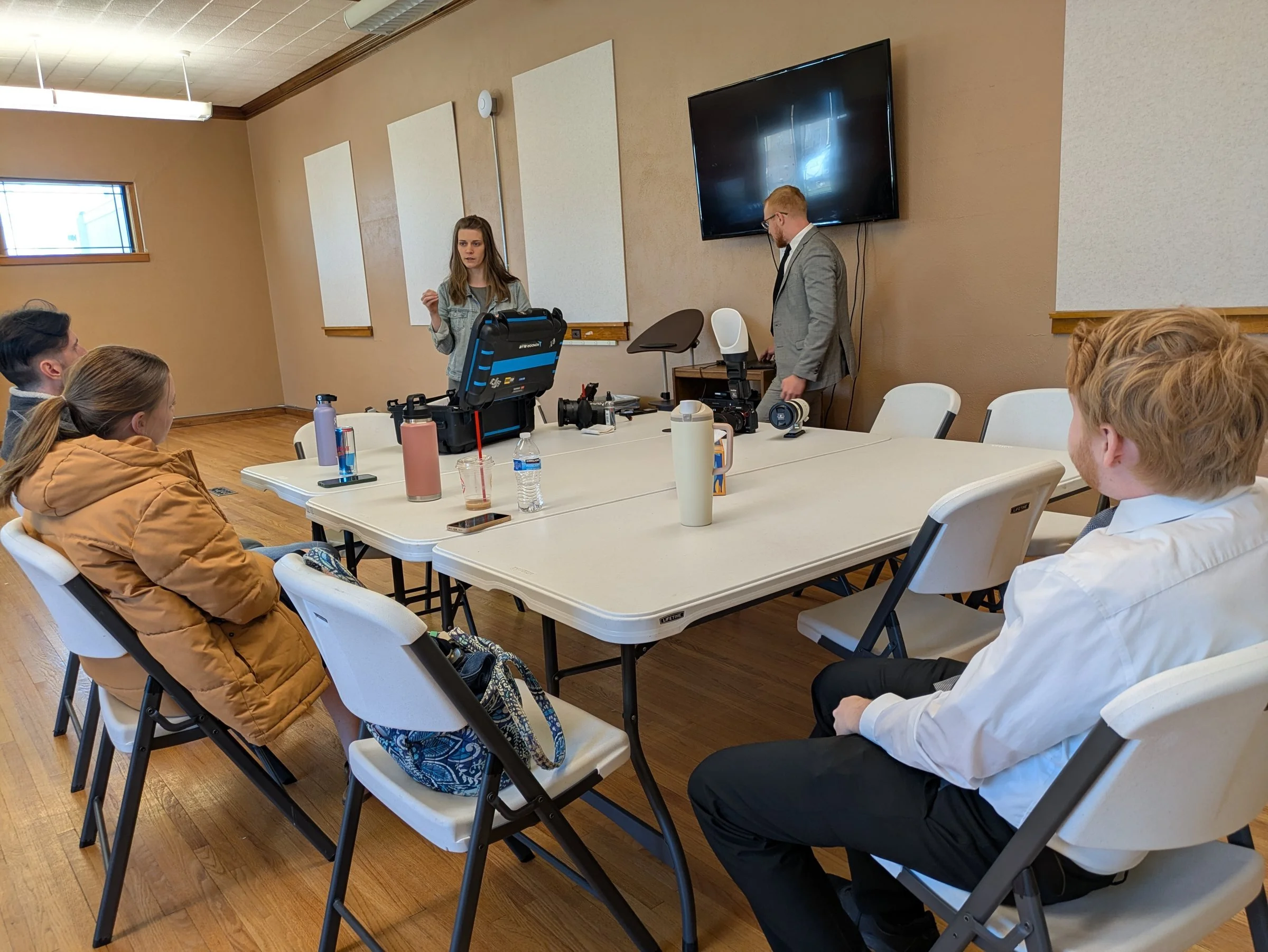 Fox Brush Films photographers and videographers reviewing camera and lighting equipment during team training in Wausa, Nebraska.