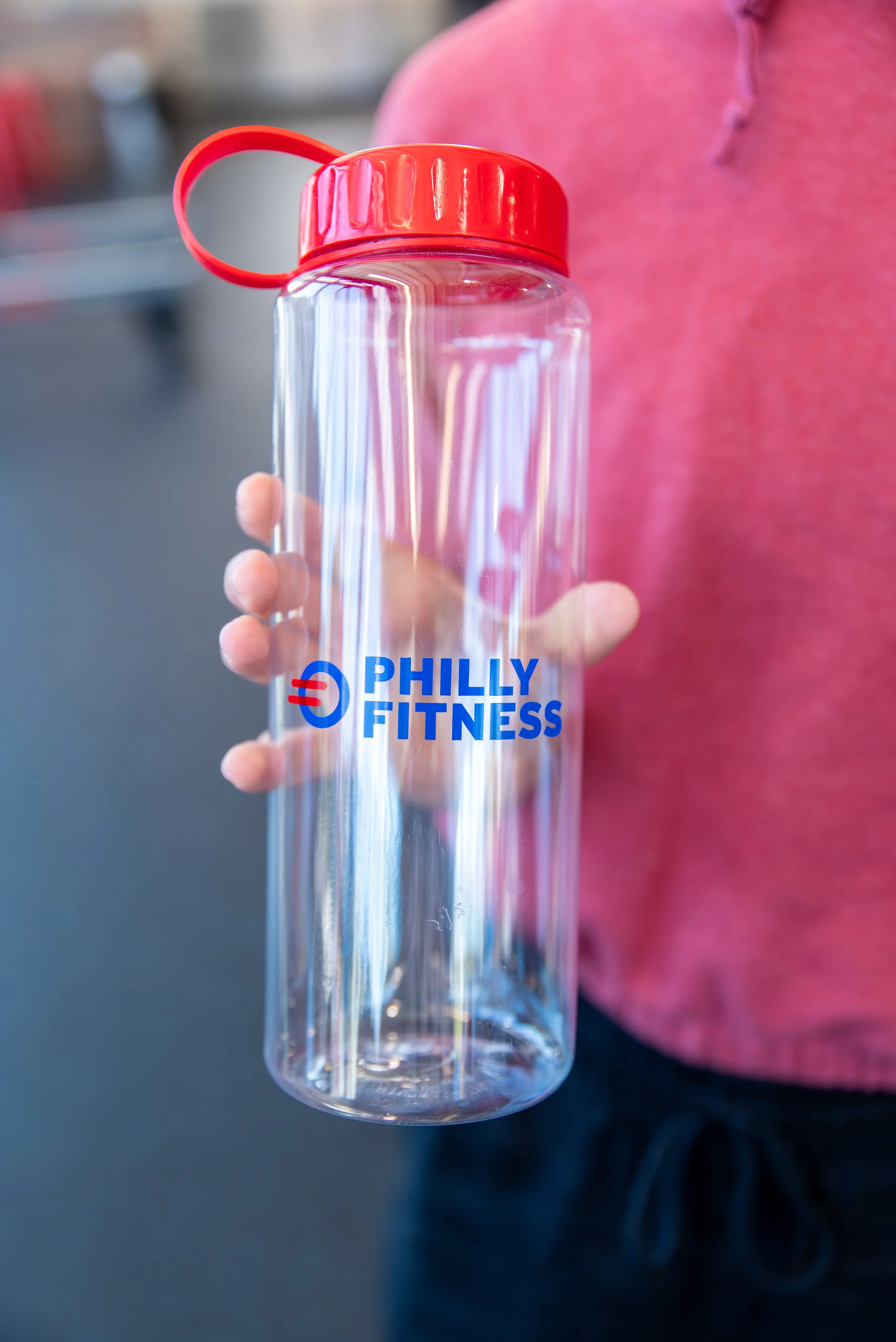 Member holding the Philly Fitness® Red Guzzler Tumbler