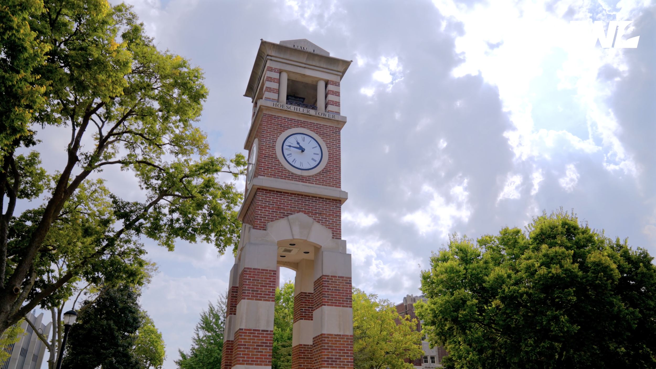 Brick clock tower surrounded by trees on the UW-La Crosse campus, from the admissions video