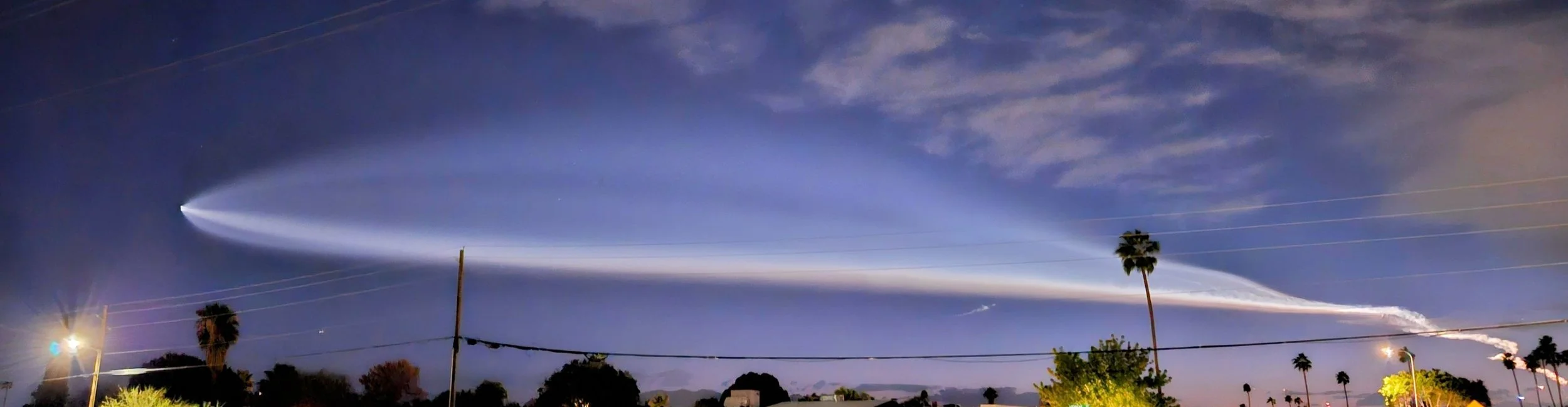 SpaceX rocket launch plume lighting up the evening sky over Phoenix, Arizona