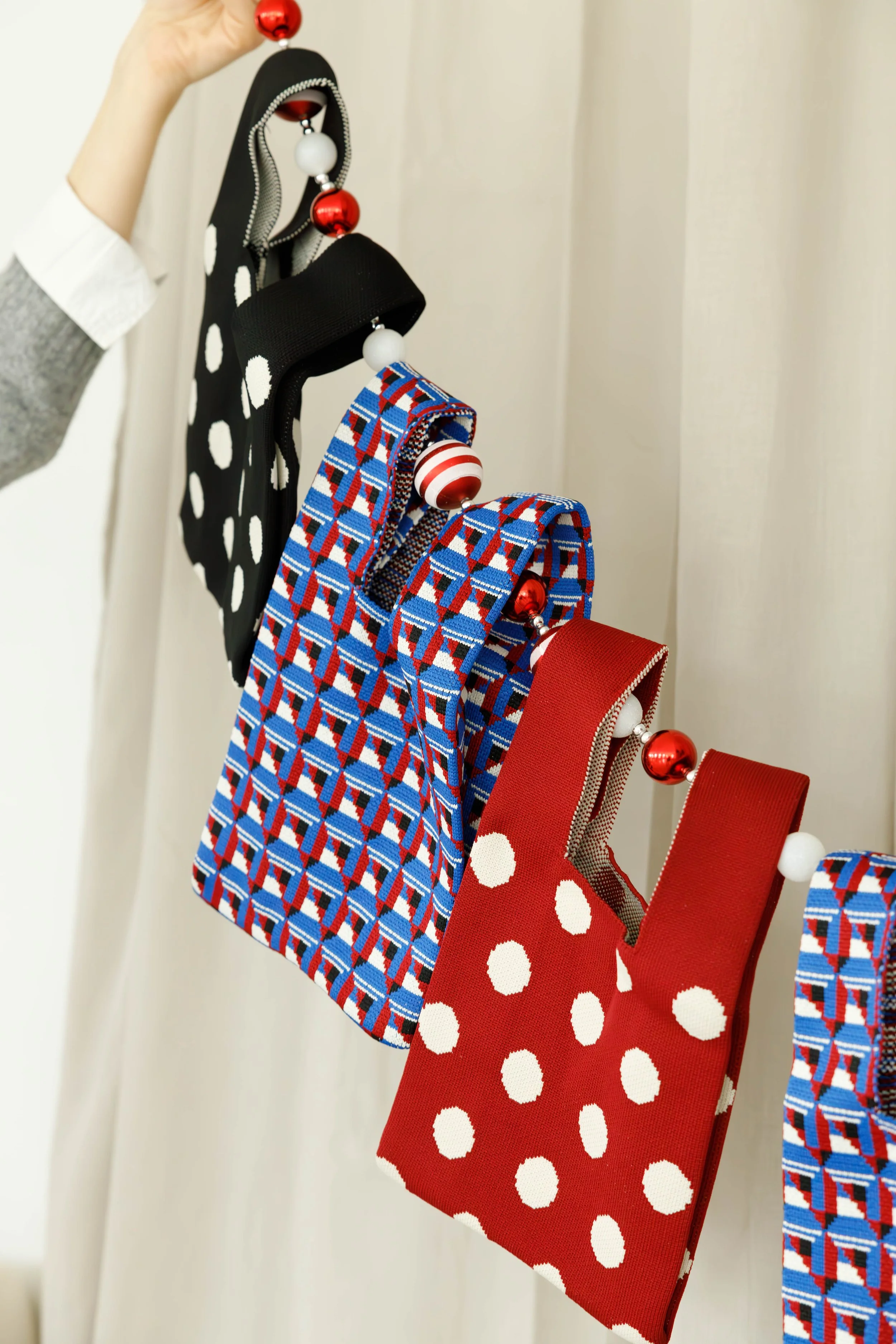 Colorful fabric headbands with holiday-themed bead decorations hanging on a display.