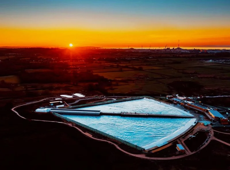 A sunset aerial view of the site with the Bristol channel in the background