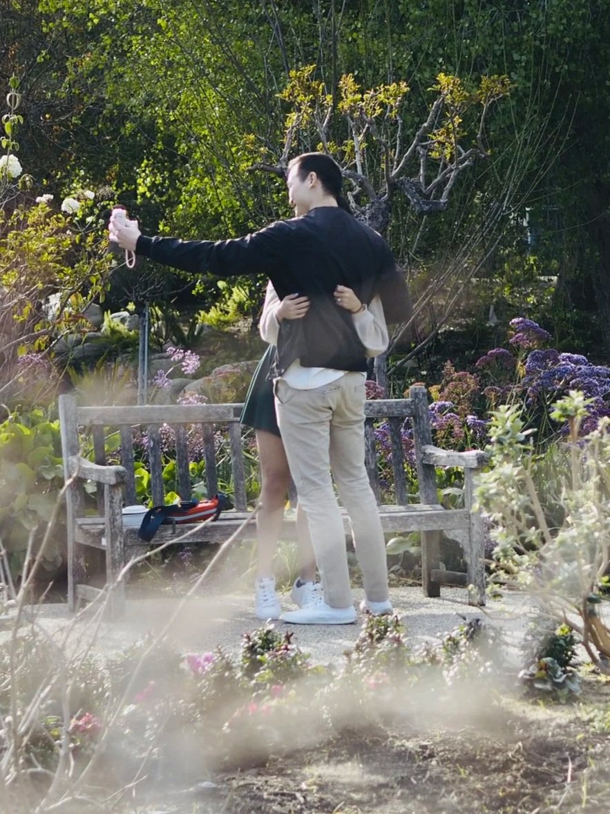Intercultural Couple Taking a Selfie Polaroid Photo In a Nice Garden