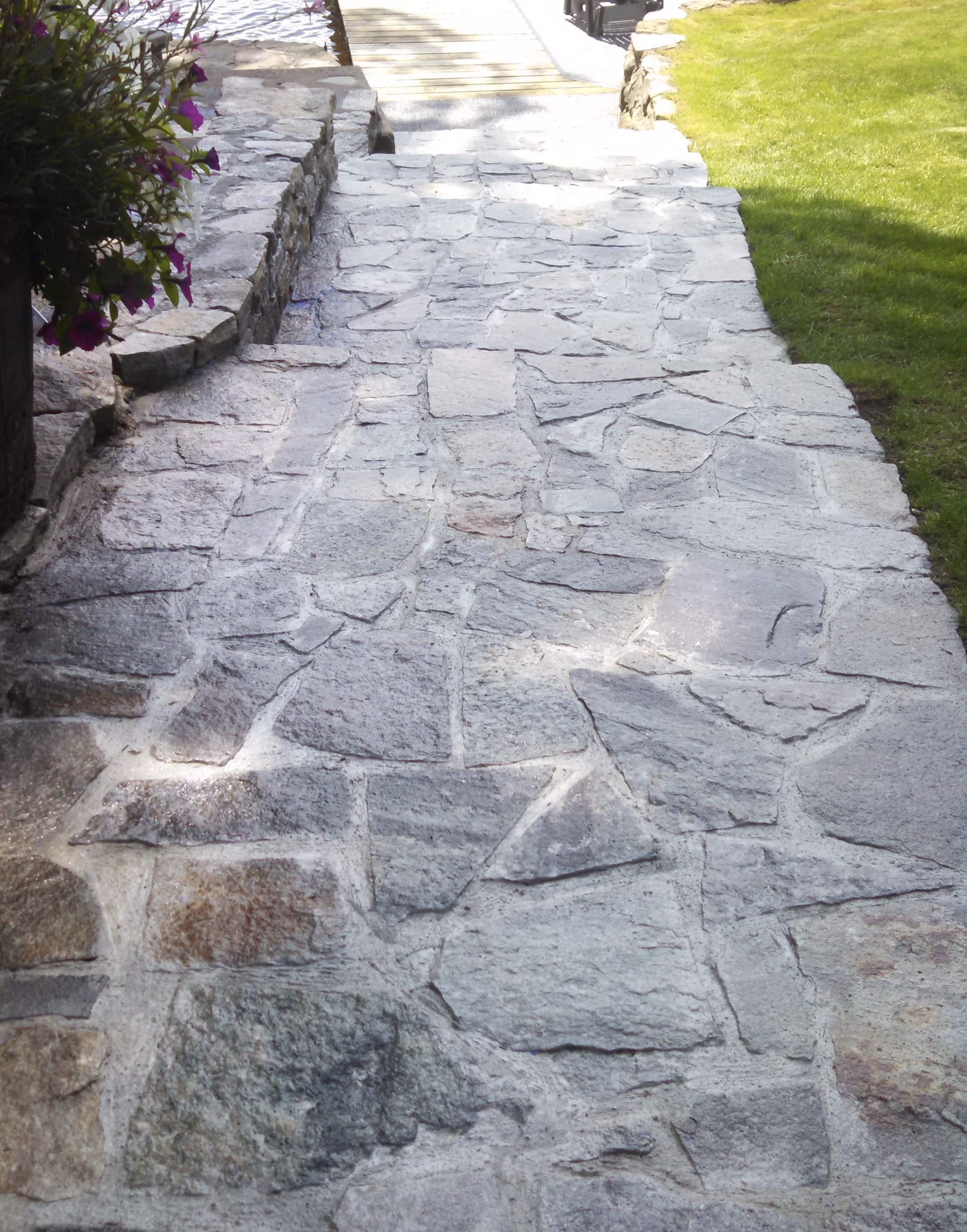 Crafted from polished granite, the steps exhibit a sleek surface that reflects the surrounding beauty