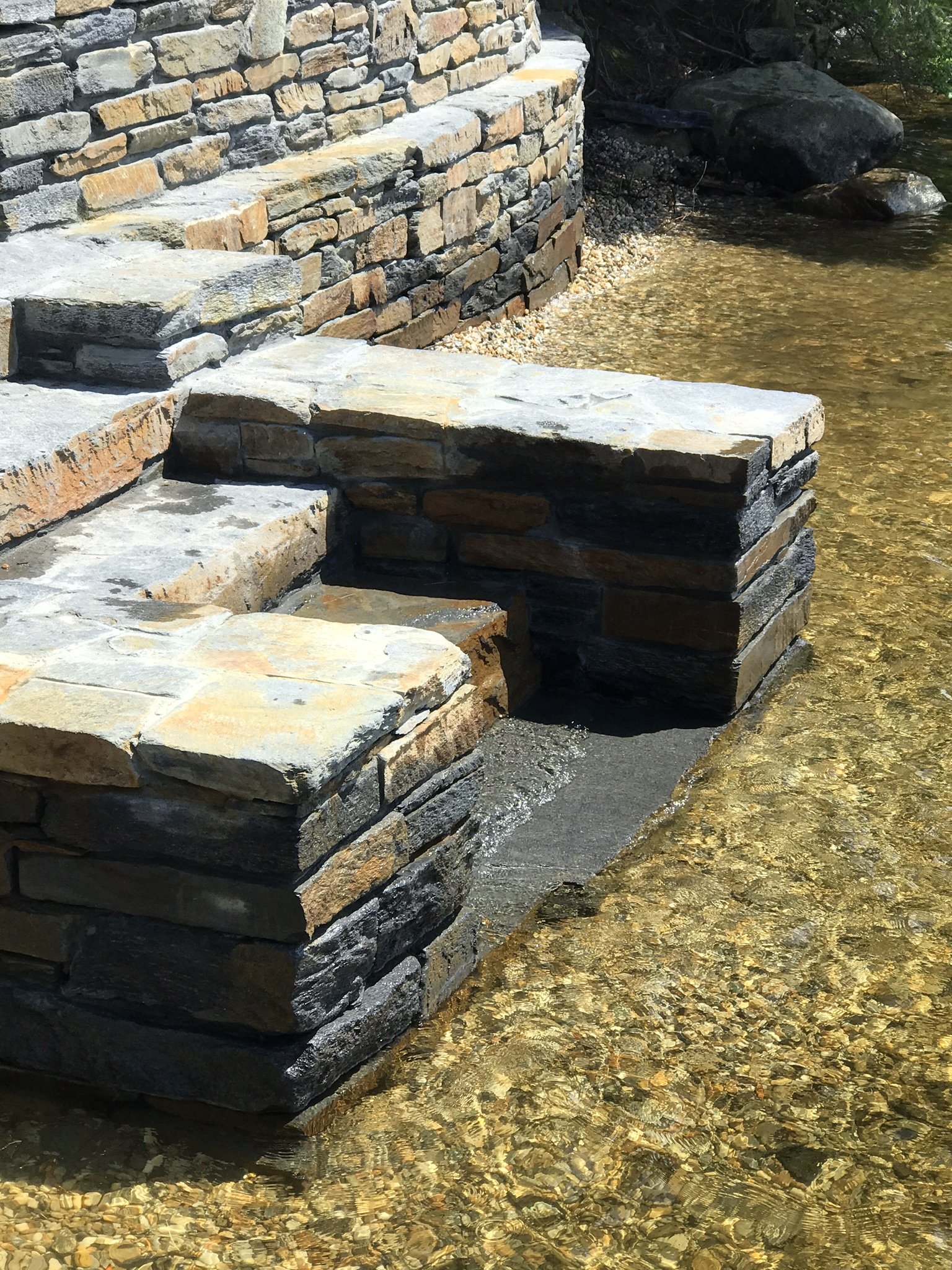 Goshen stone steps leading to water embody a tranquil and scenic pathway