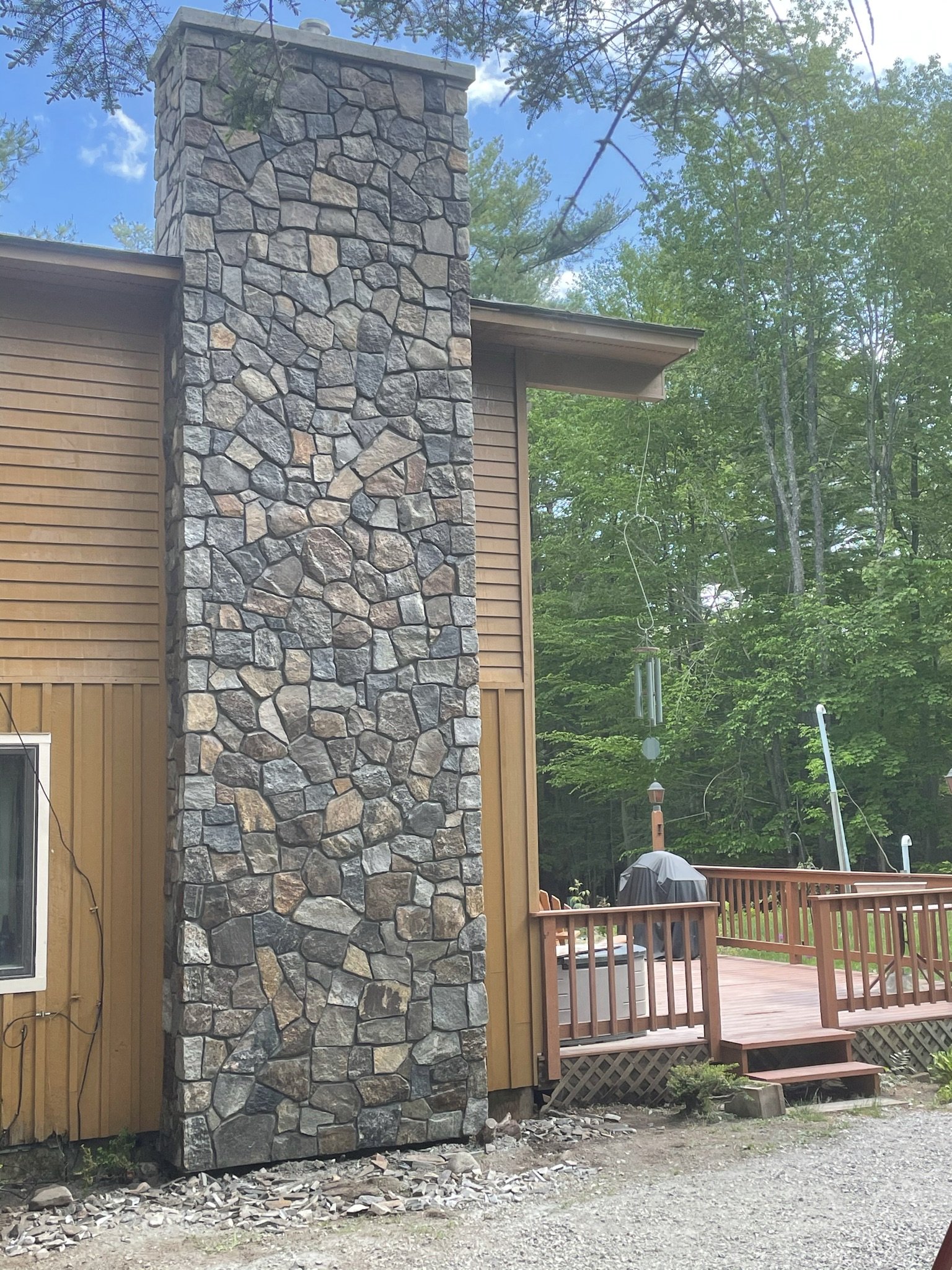 A native field stone chimney exudes rustic charm and natural beauty. Constructed using locally sourced field stones, this chimney embraces the earthy tones and irregular shapes of stones found in the surrounding environment