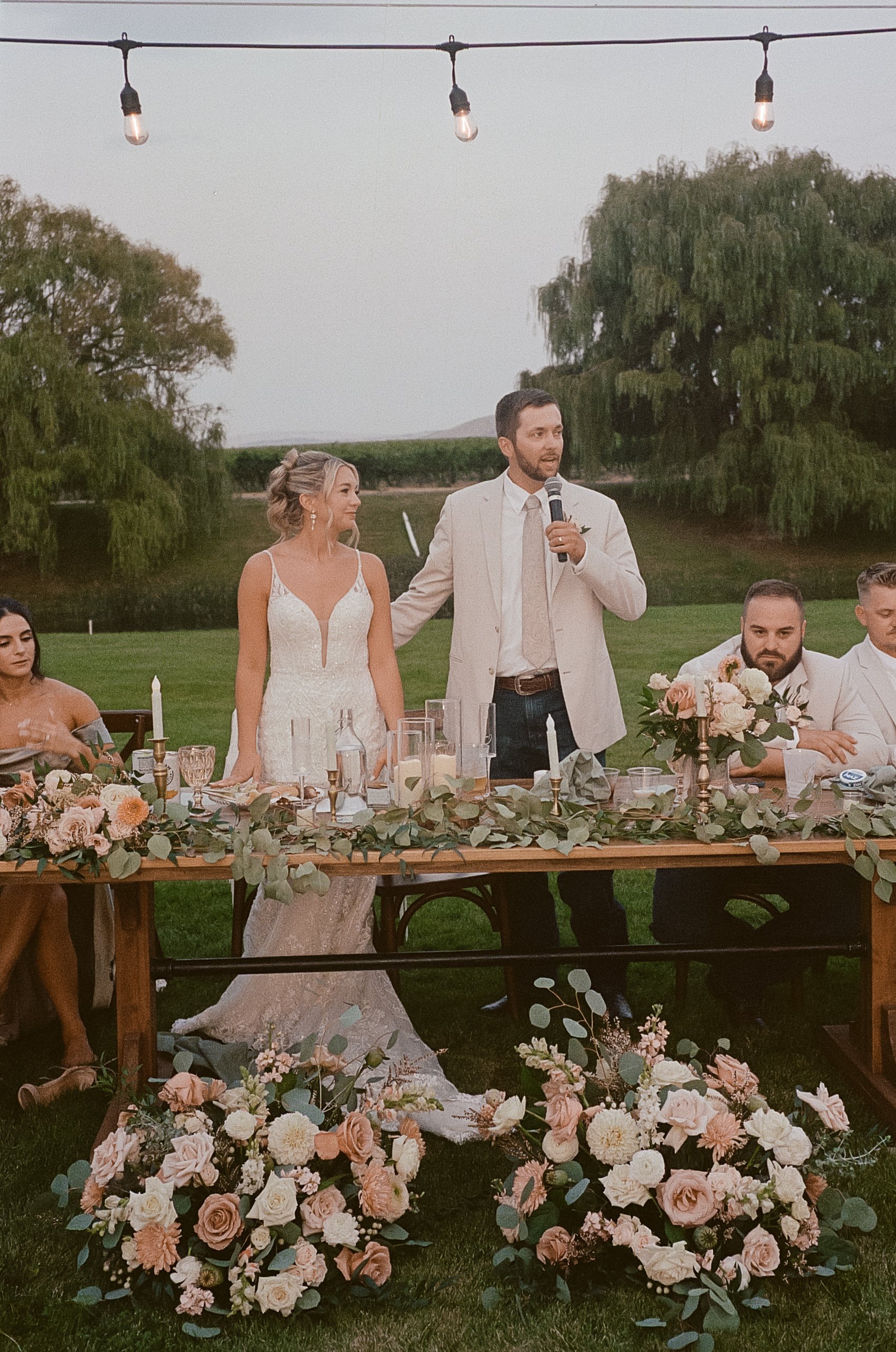 Soft blush, peach, and sage wedding with roses, poppy pods, calcynia, eucalyptus, ranunculus, dahlias at Gooseridge Winery Park Benton City WA