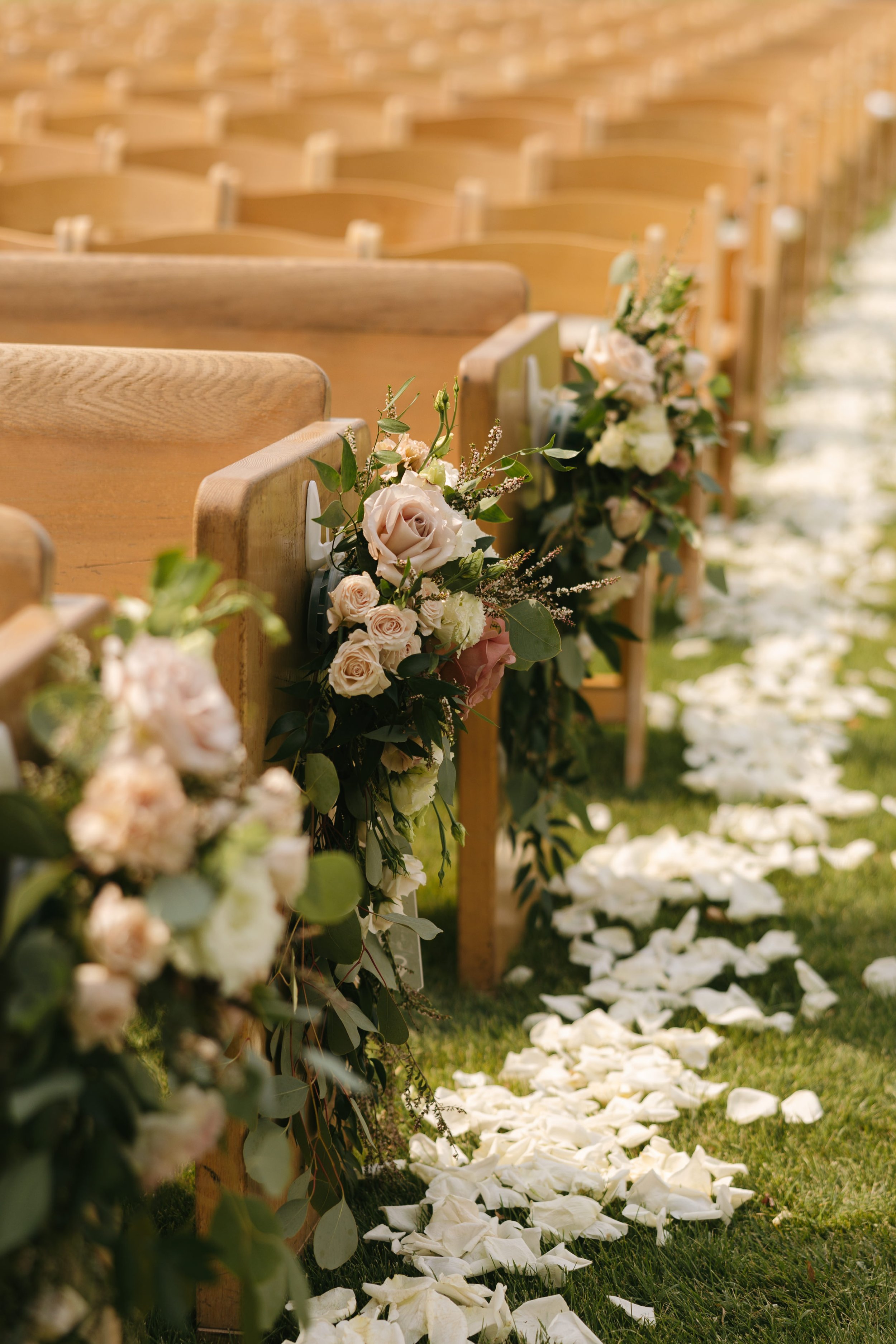 Soft blush, peach, and sage wedding with roses, poppy pods, calcynia, eucalyptus, ranunculus, dahlias at Gooseridge Winery Park Benton City WA Aisle flowers