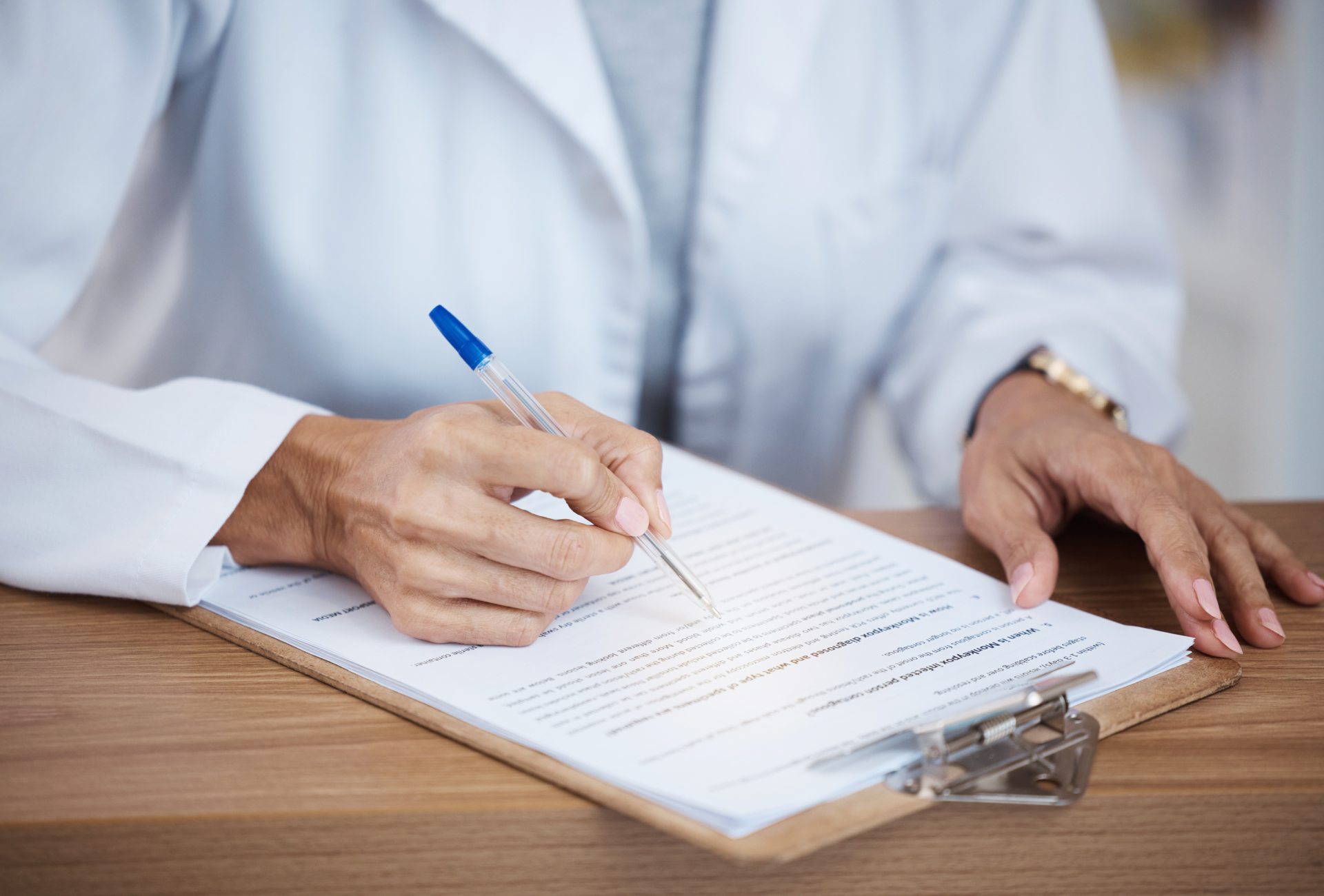 person filling out form on clip board