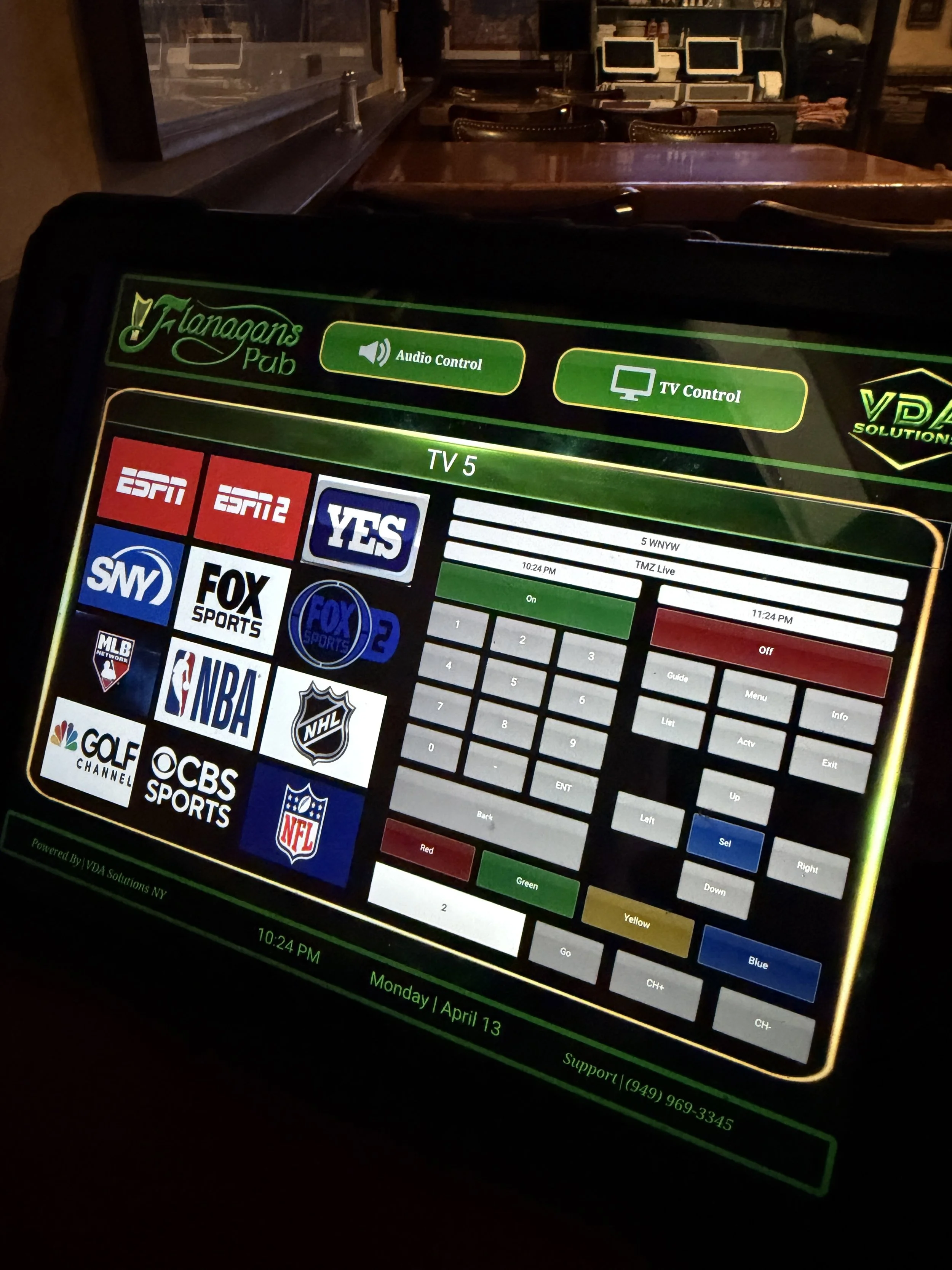 TV control screen at a pub showing various cable channels including ESPN, ESPN2, YES, FOX Sports, FOX Sports 2, MLB, NBA, NHL, Golf Channel, CBS Sports, NFL, and others.