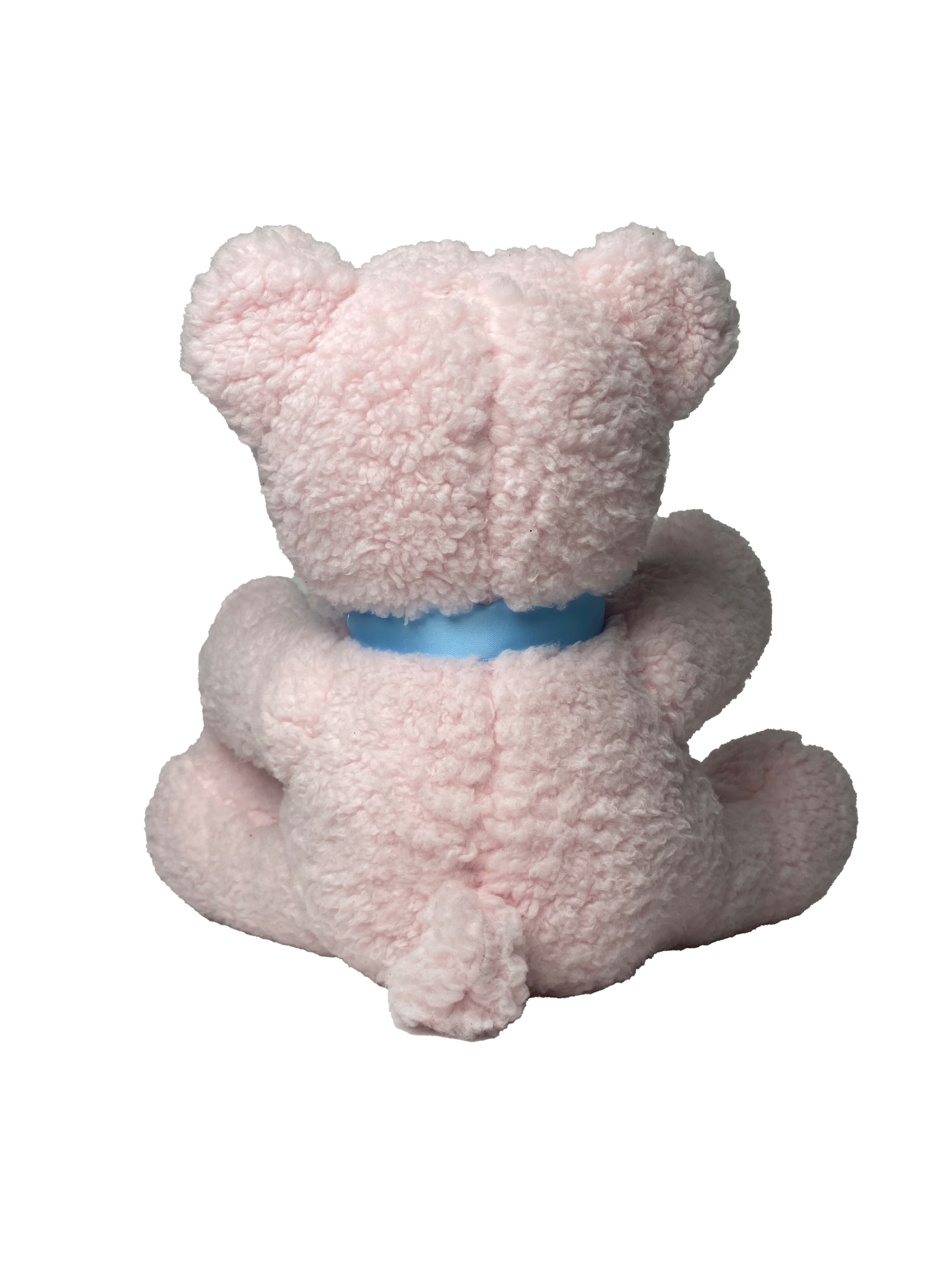 A plush teddy bear with light pink, curly fur sitting on a surface. The bear is wearing a blue ribbon around its neck.
