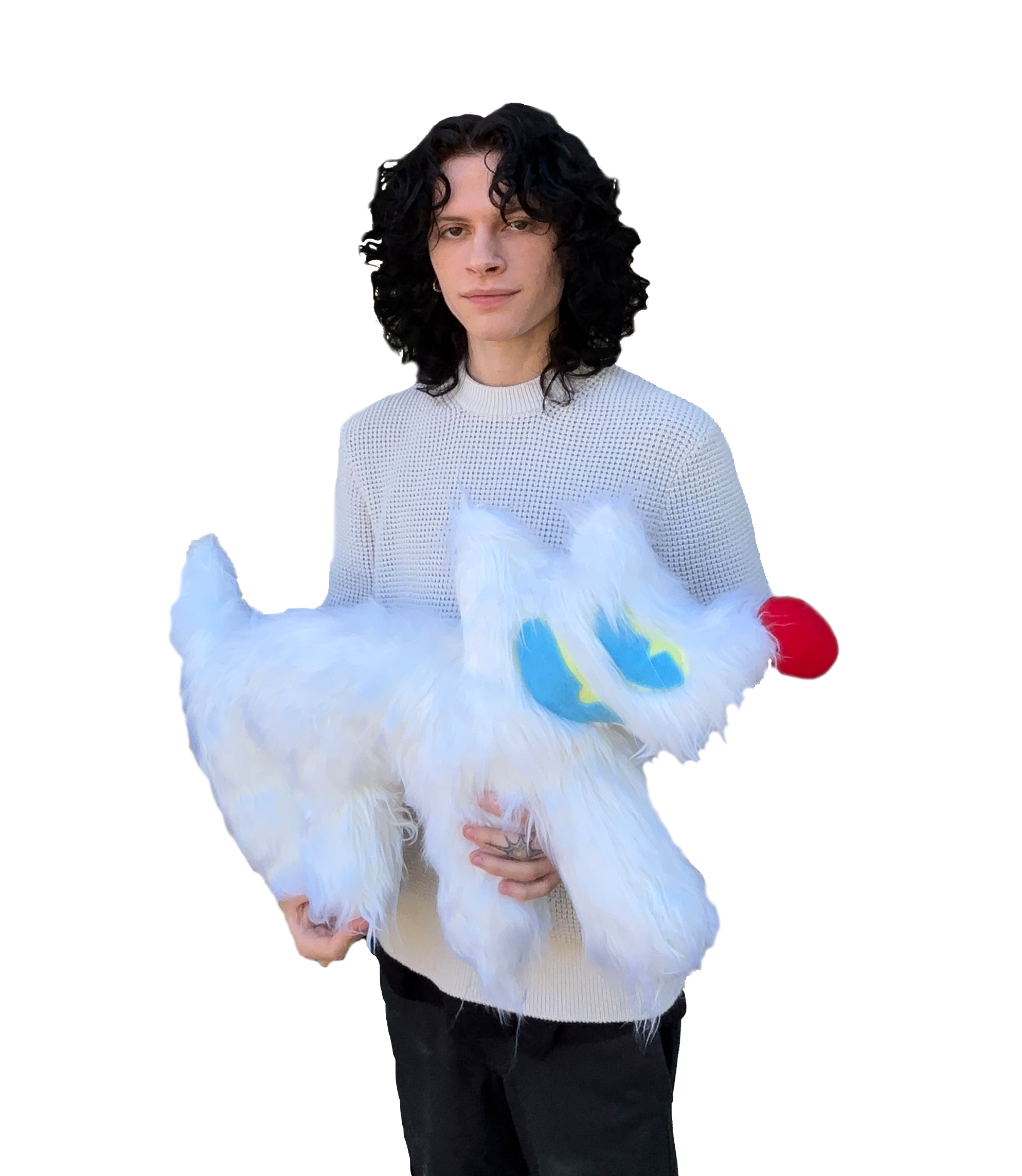 A person with curly dark hair, wearing a white sweater, holding a fluffy white bird with blue markings, standing against a colorful background.