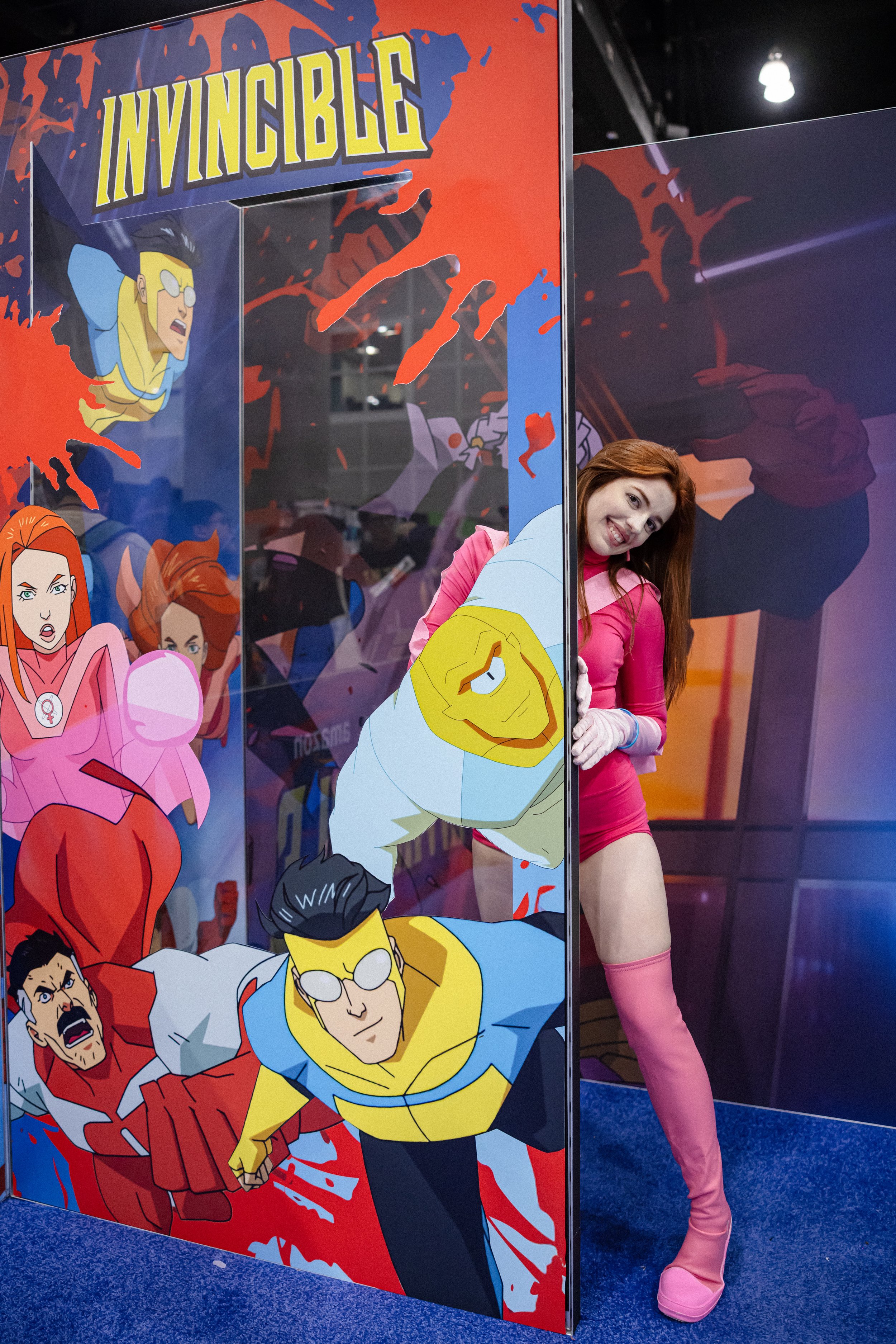 People holding collectible toy boxes in a store with shelves in the background.