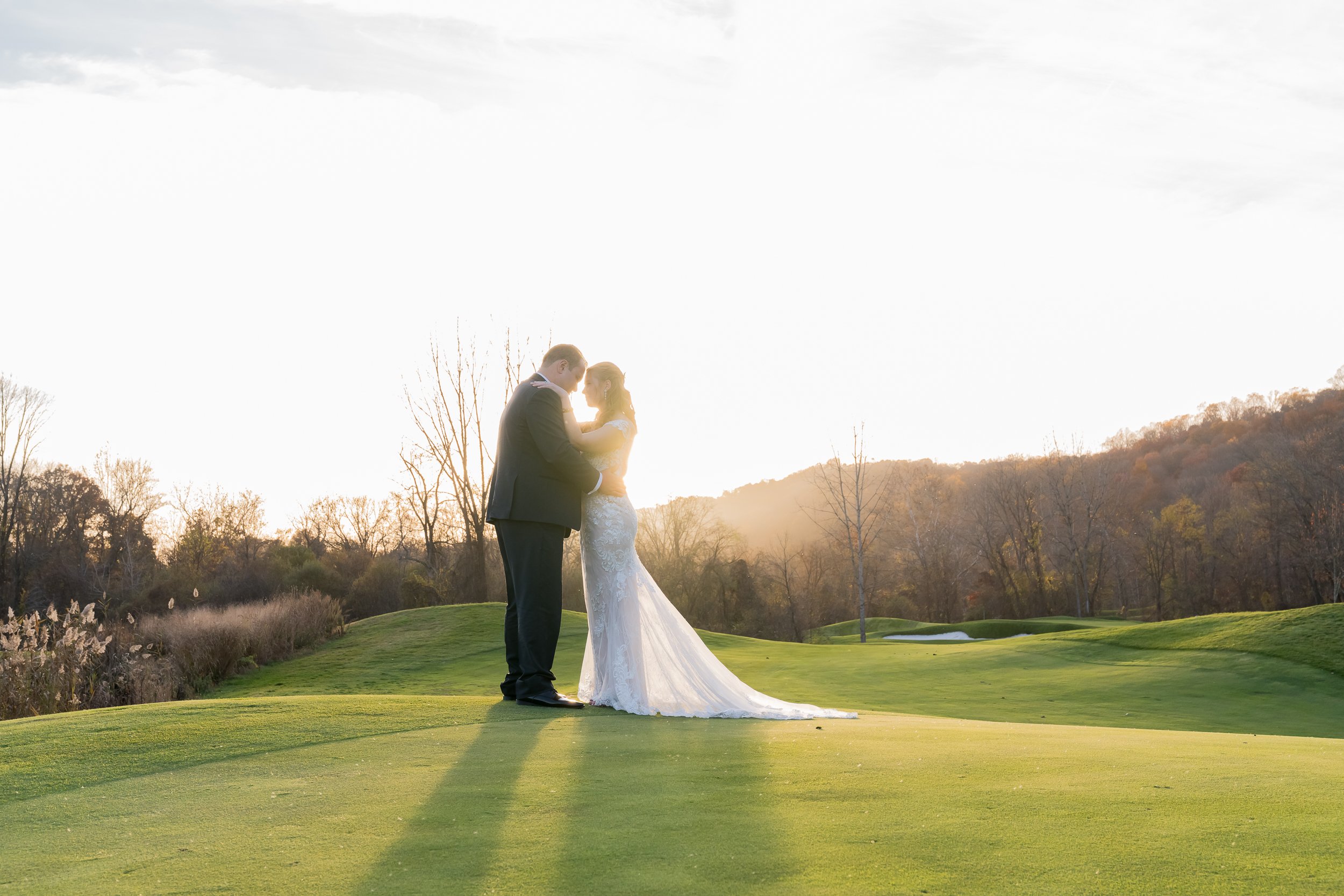 cCouple at golf field during sunset at Hollow Brook Club Wedding