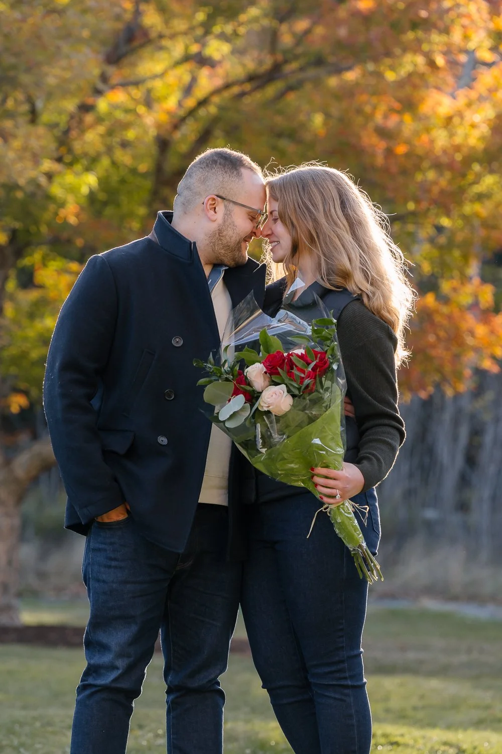 Adam and Andrea touching foreheads and holding flower in Catskills NY