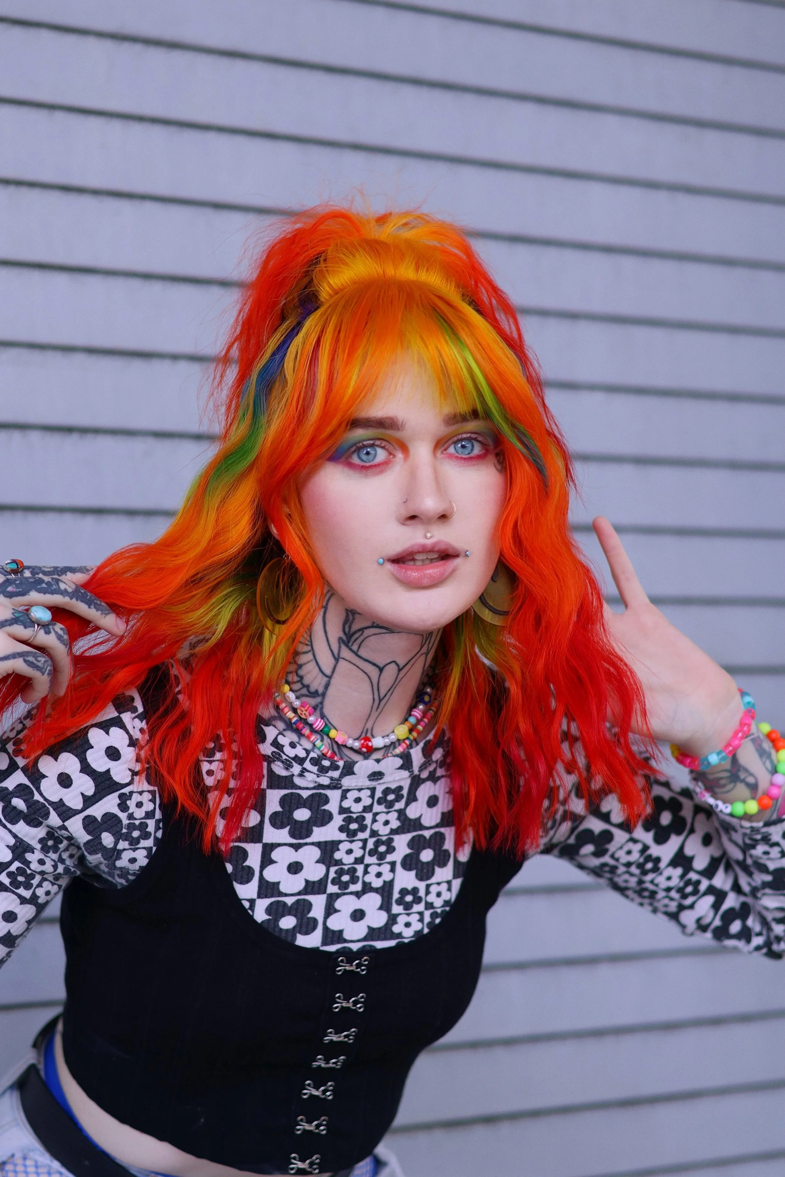 A young woman with bright rainbow-colored hair. Vivid rainbow hair color.